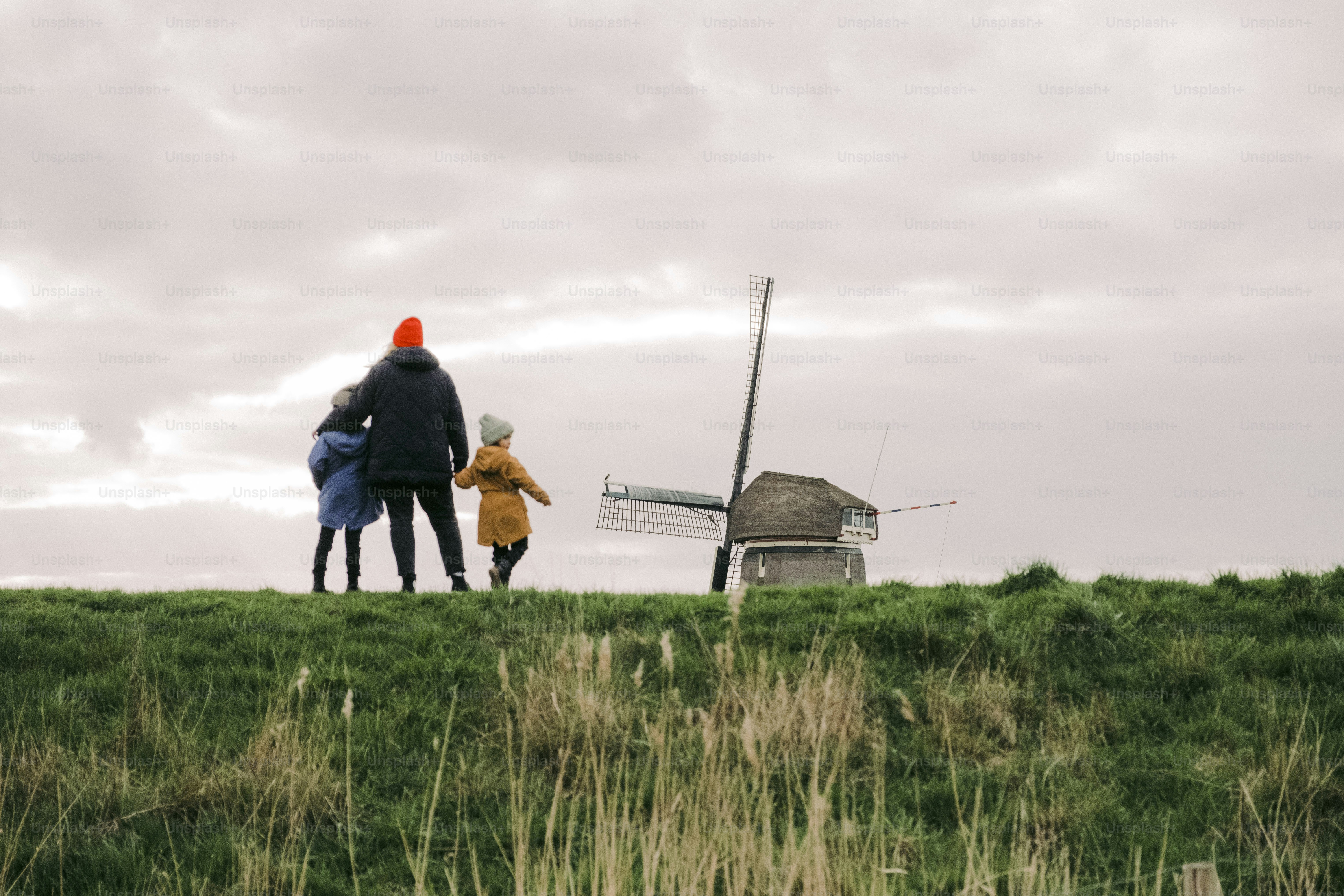 A couple of people that are standing in the grass