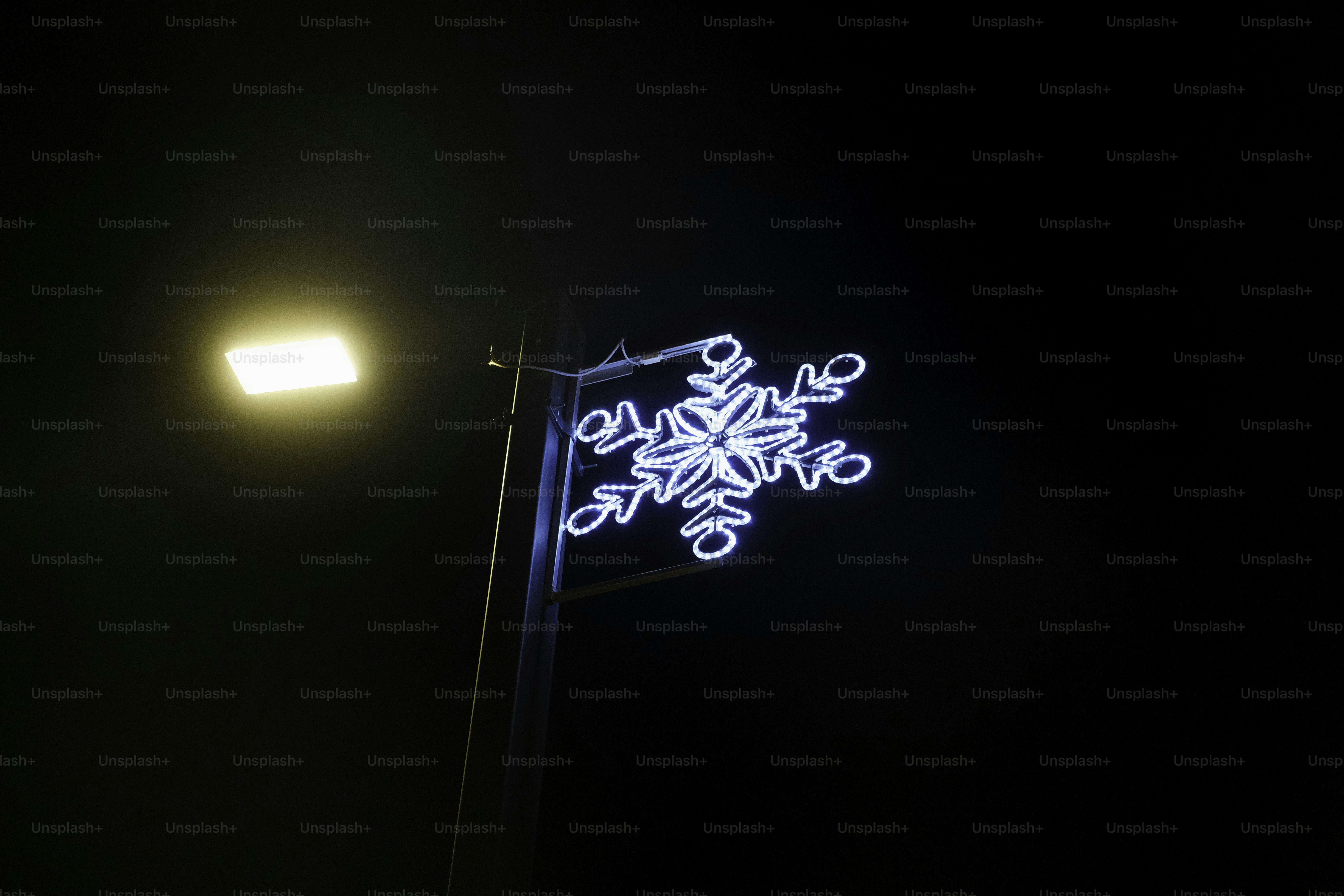 A street light with a snowflake on it