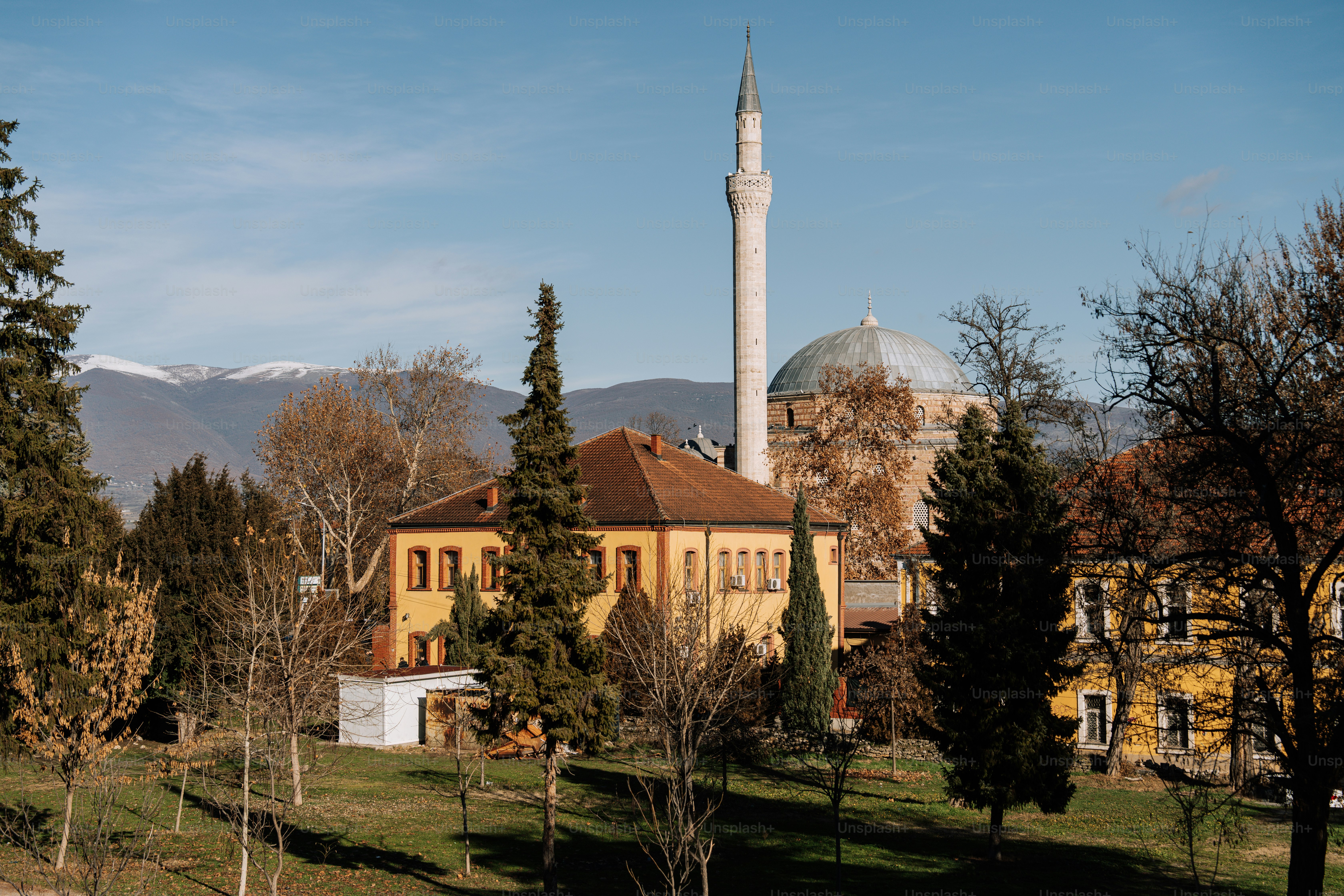 A large building with a tower in the middle of a field
