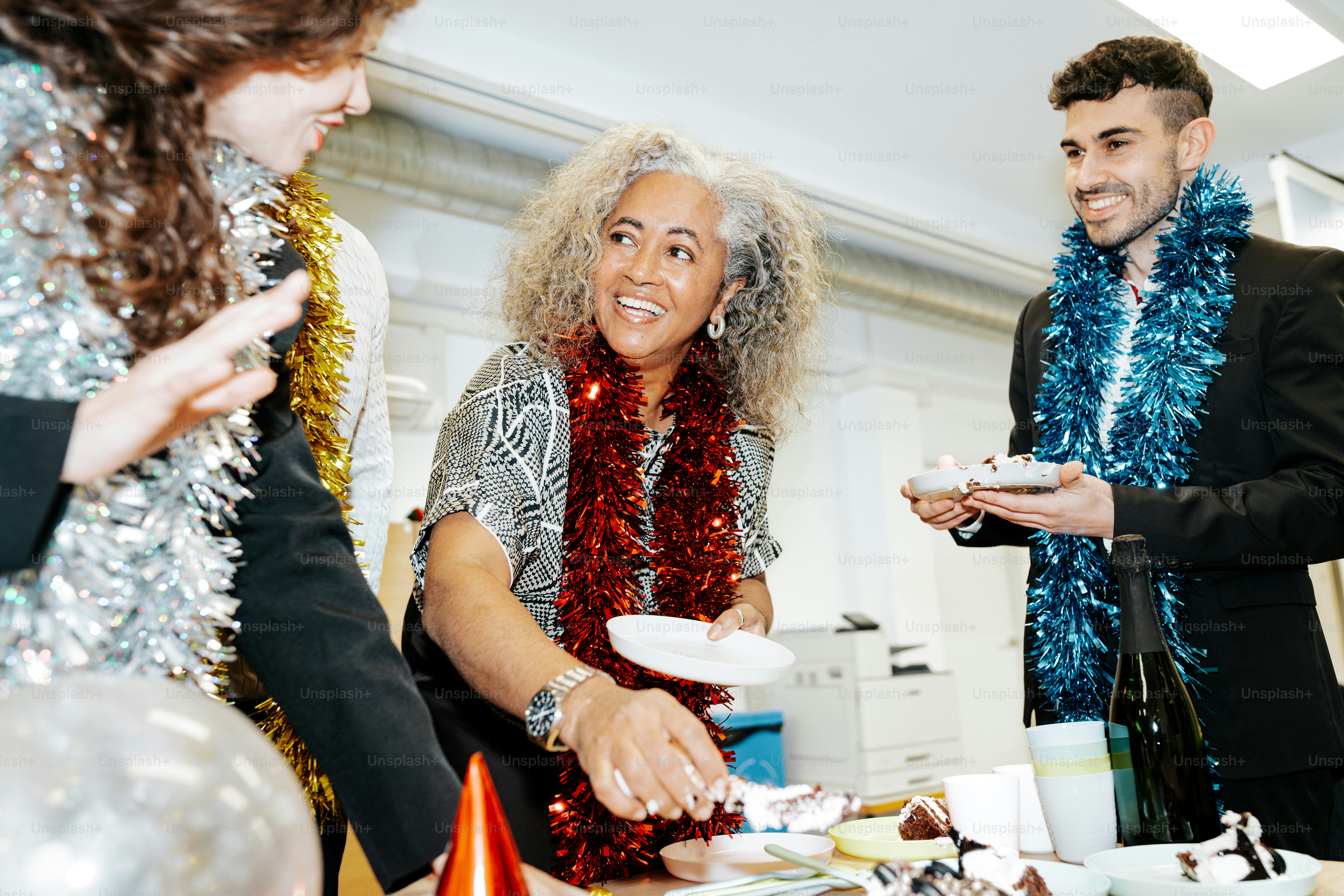 A group of people standing around a table photo – Party Image on Unsplash