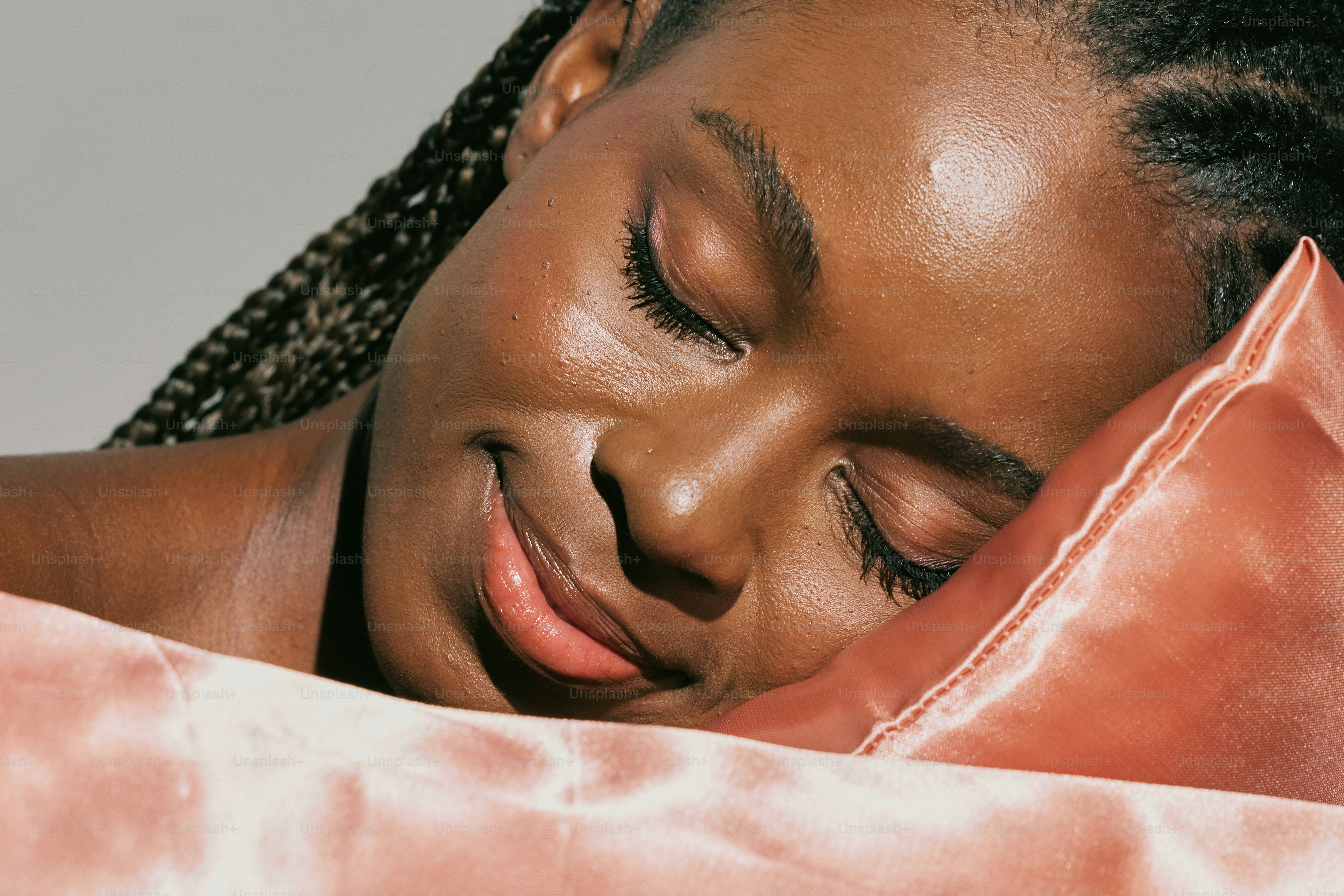 A woman laying in bed with her eyes closed