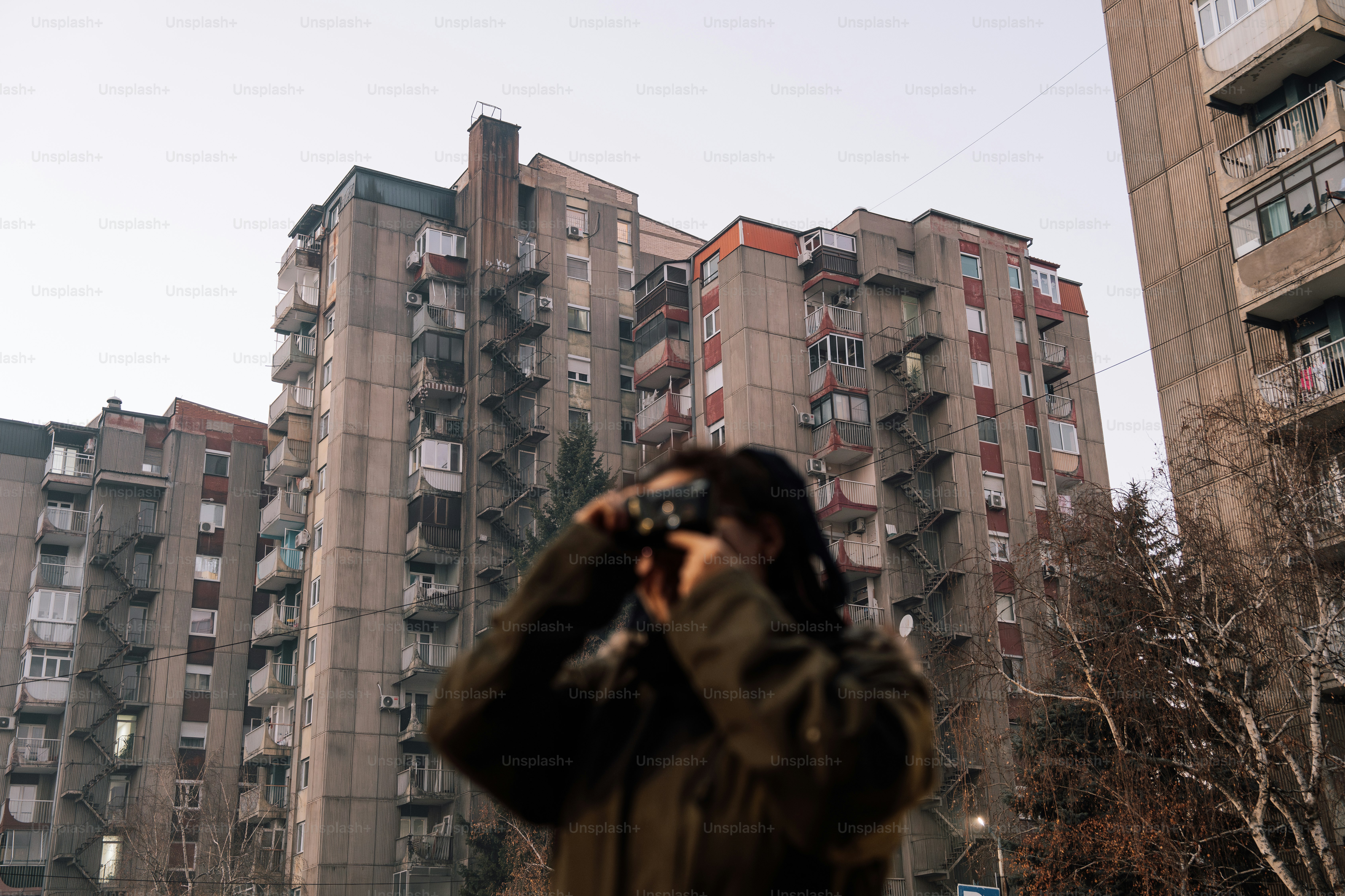 A man taking a picture of a tall building