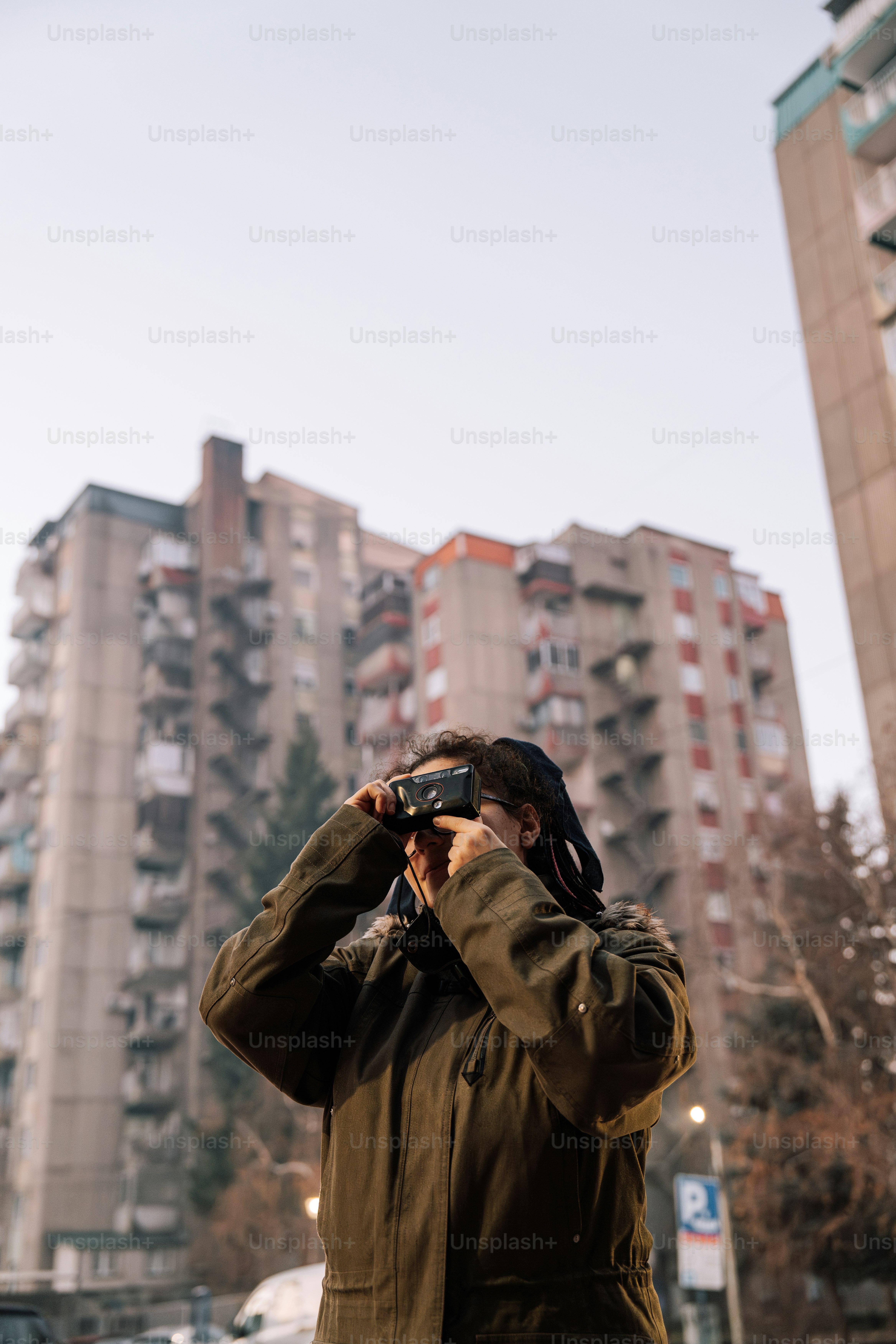 A man taking a picture of a tall building
