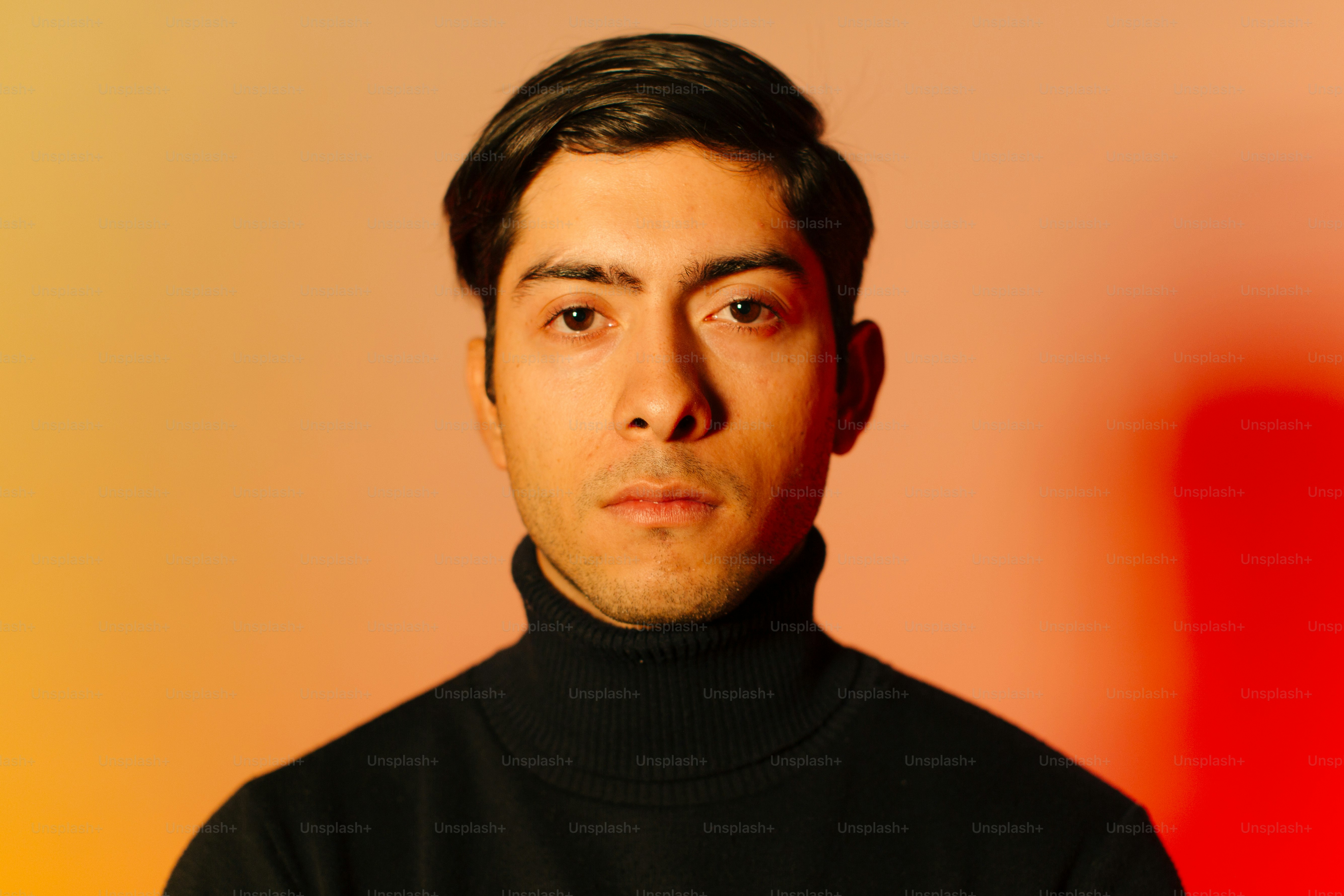 A man wearing a black turtle neck sweater