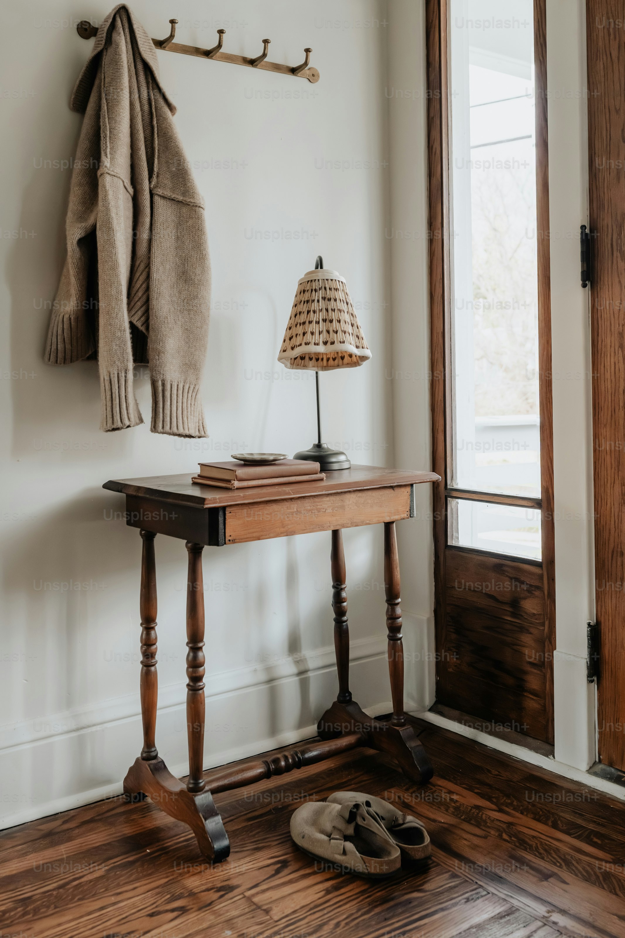 A room with a wooden floor and a coat rack