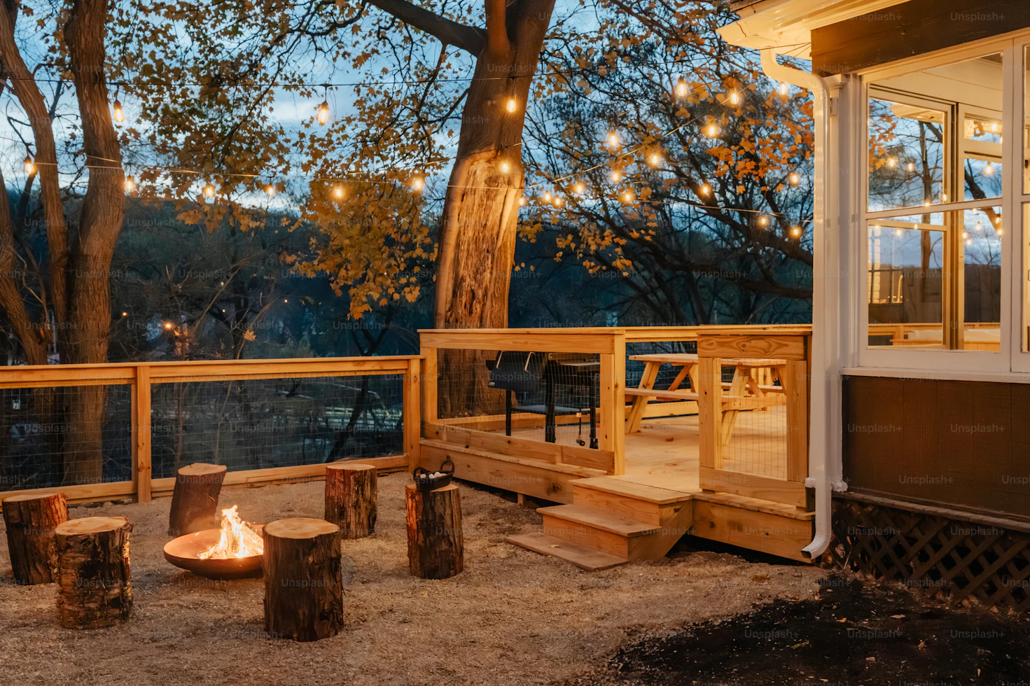 Warm glowing string lights hanging above a nighttime outdoor party