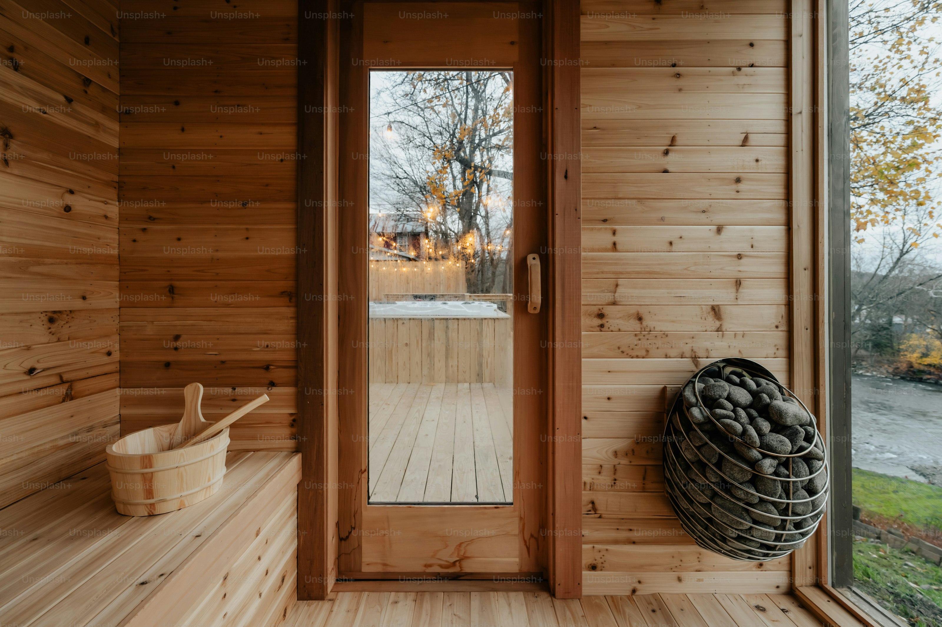 A wooden room with a bench and a door