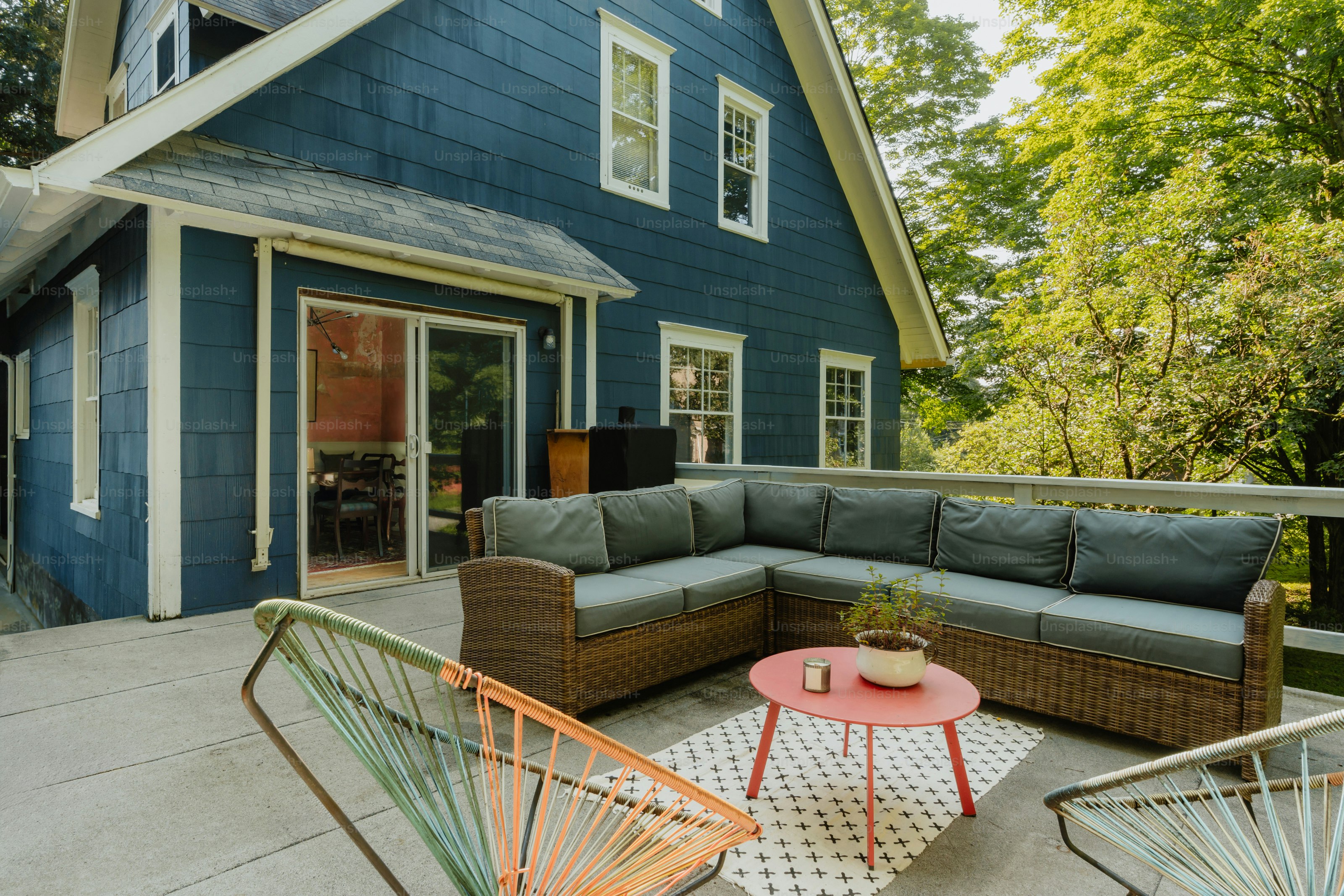 Large outdoor misting fans cooling a backyard patio seating area during summer heat