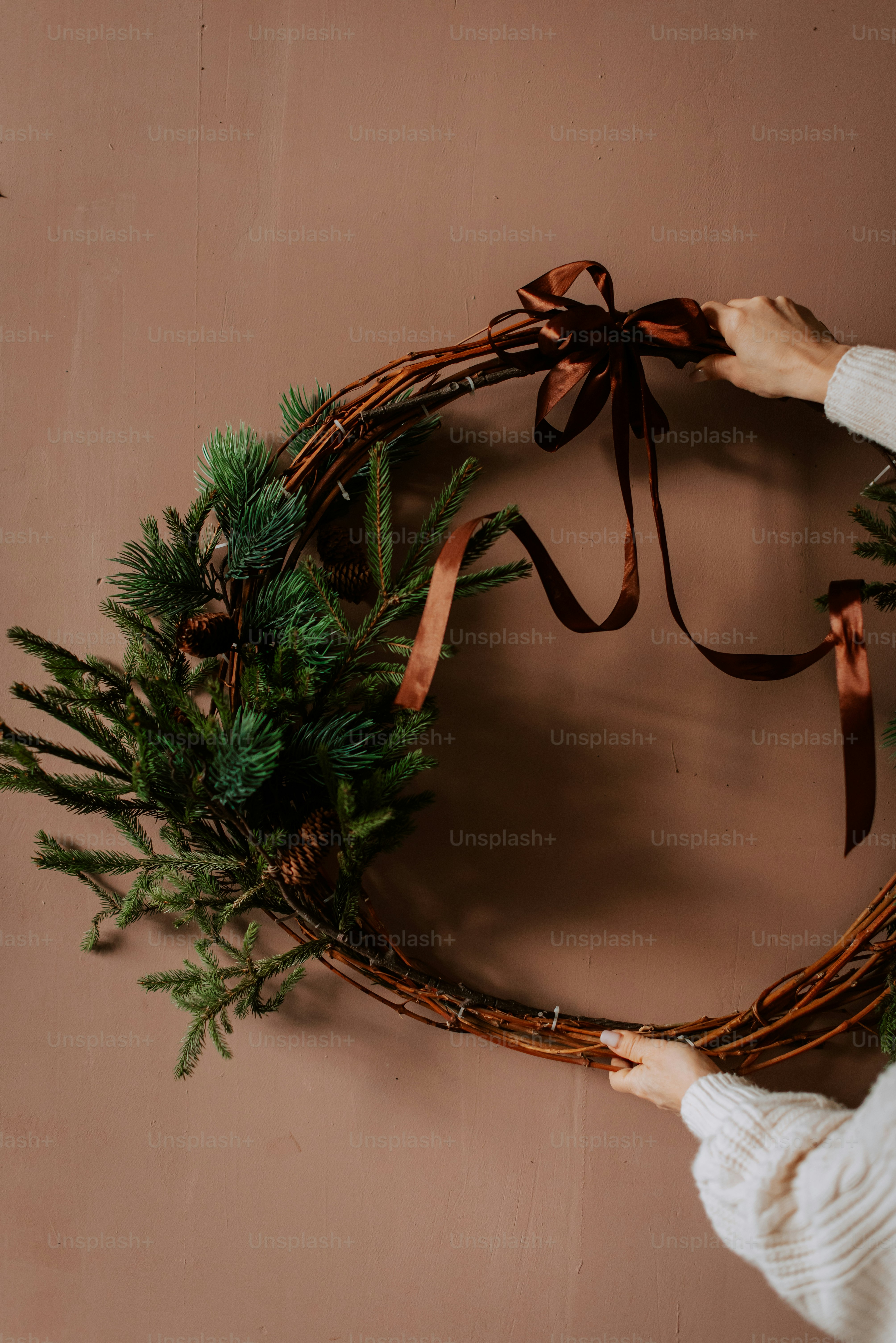 A woman holding a wreath on a wall