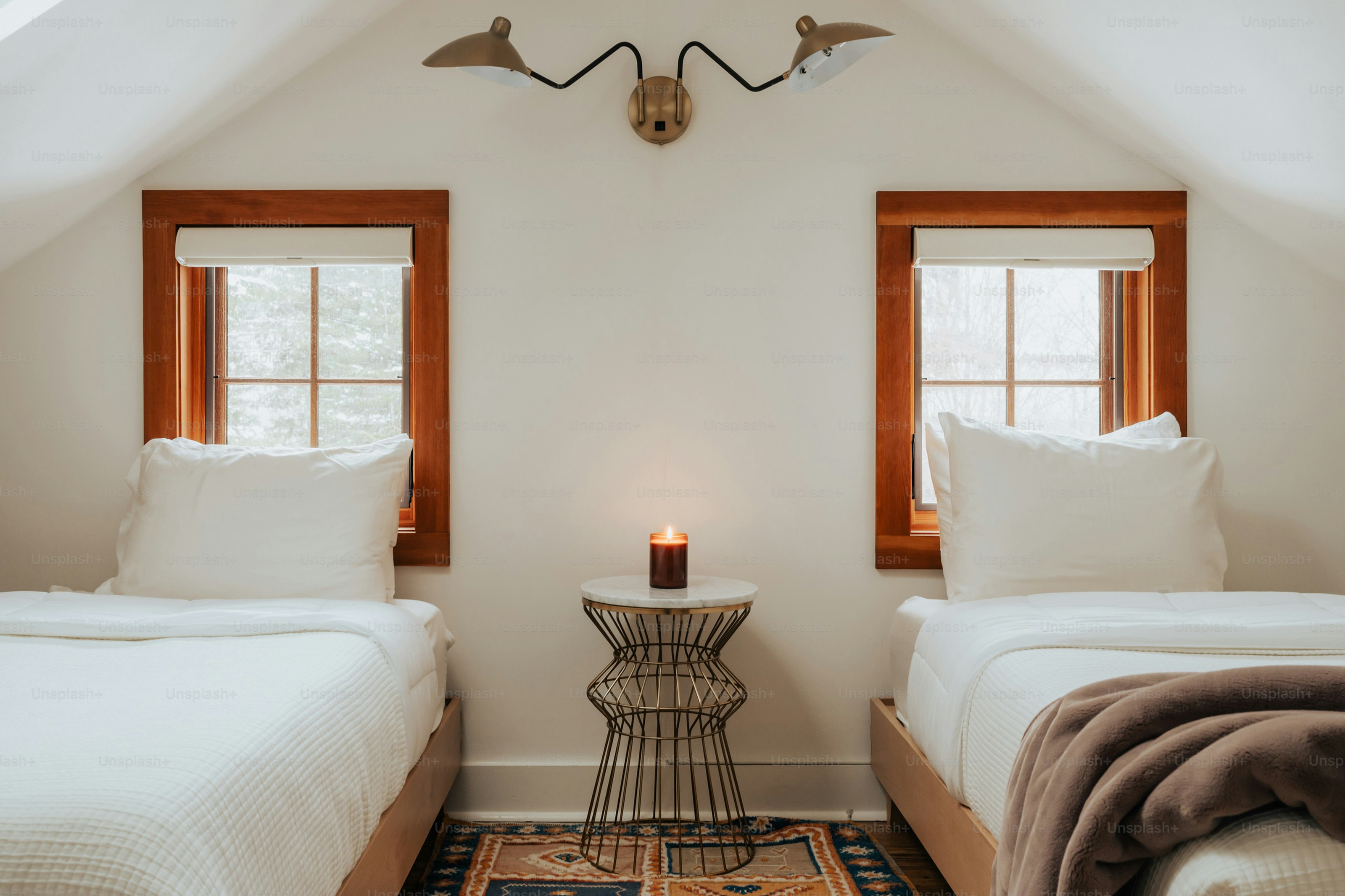 A bedroom with two beds and a rug