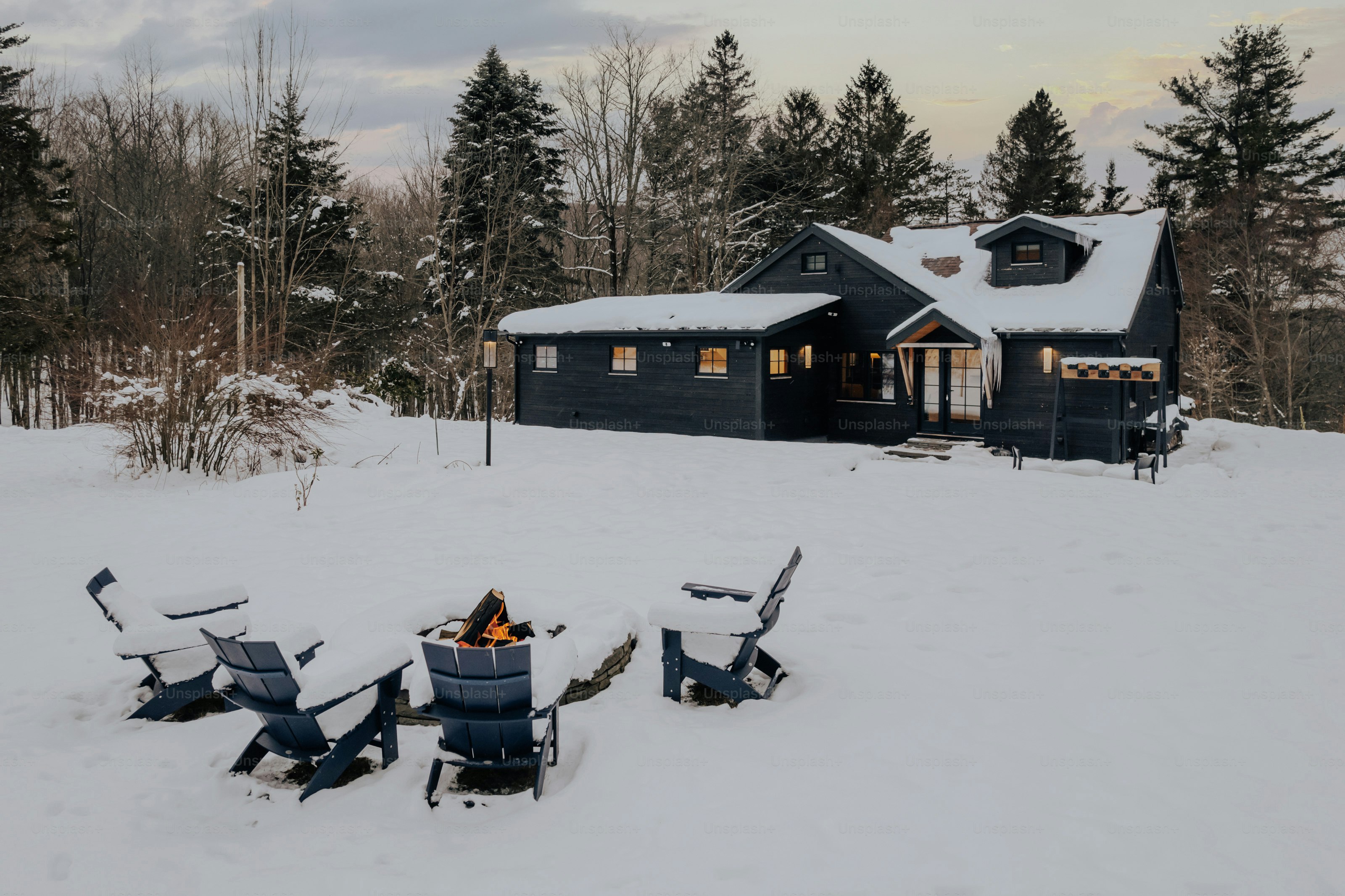 A group of chairs sitting on top of a snow covered field