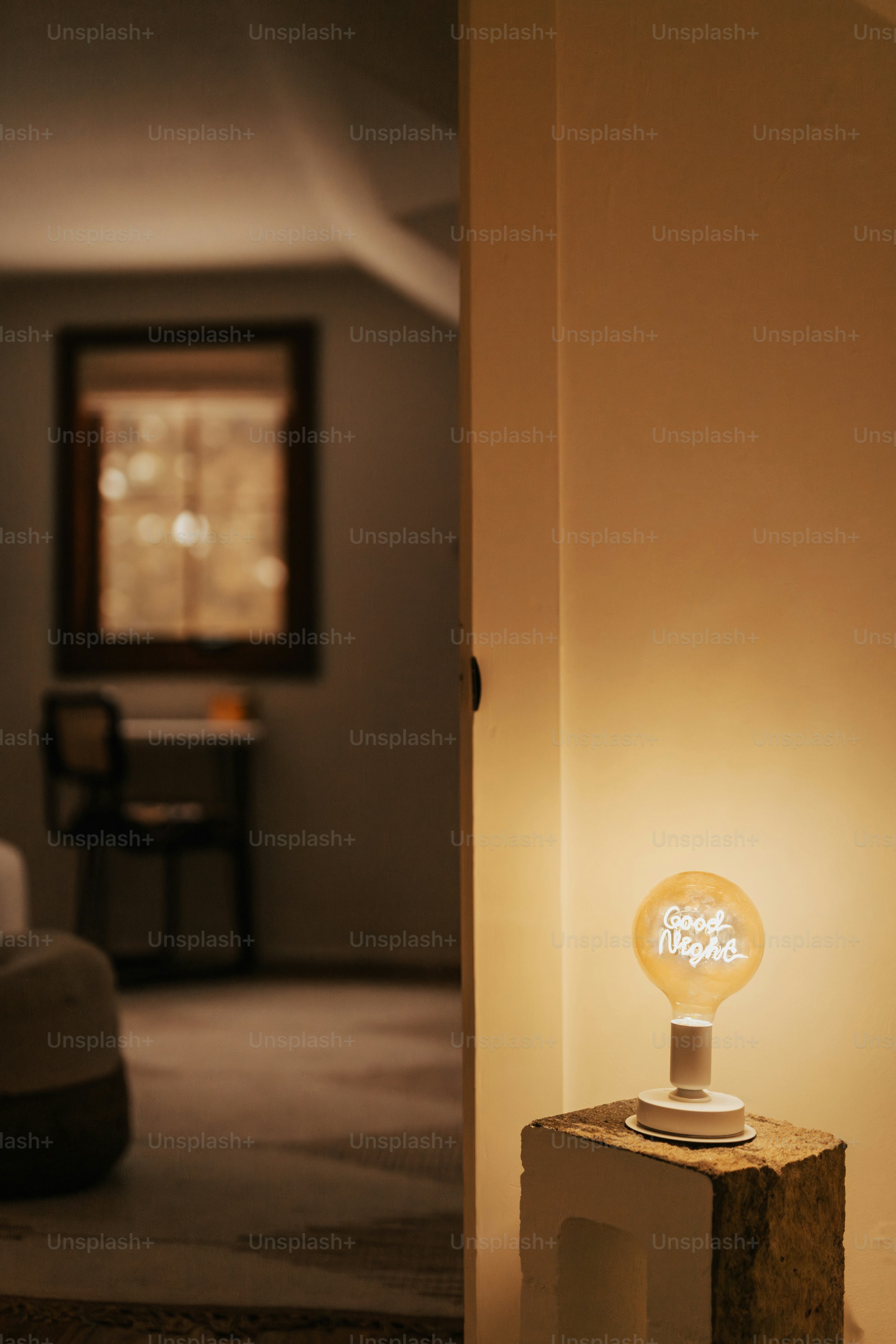 Una stanza con un letto e un tavolo con una lampada sopra