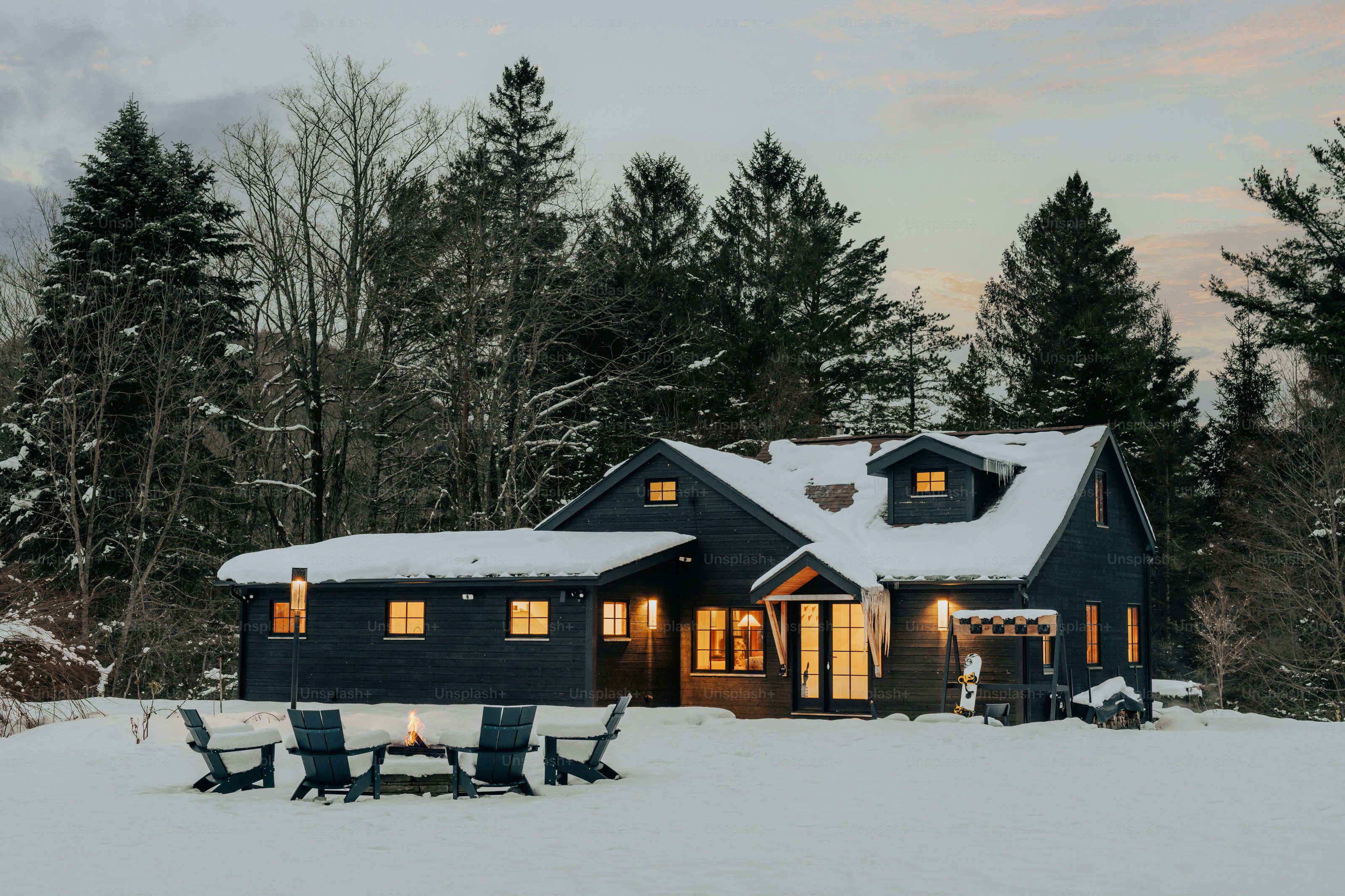 A house with a lot of snow on the ground