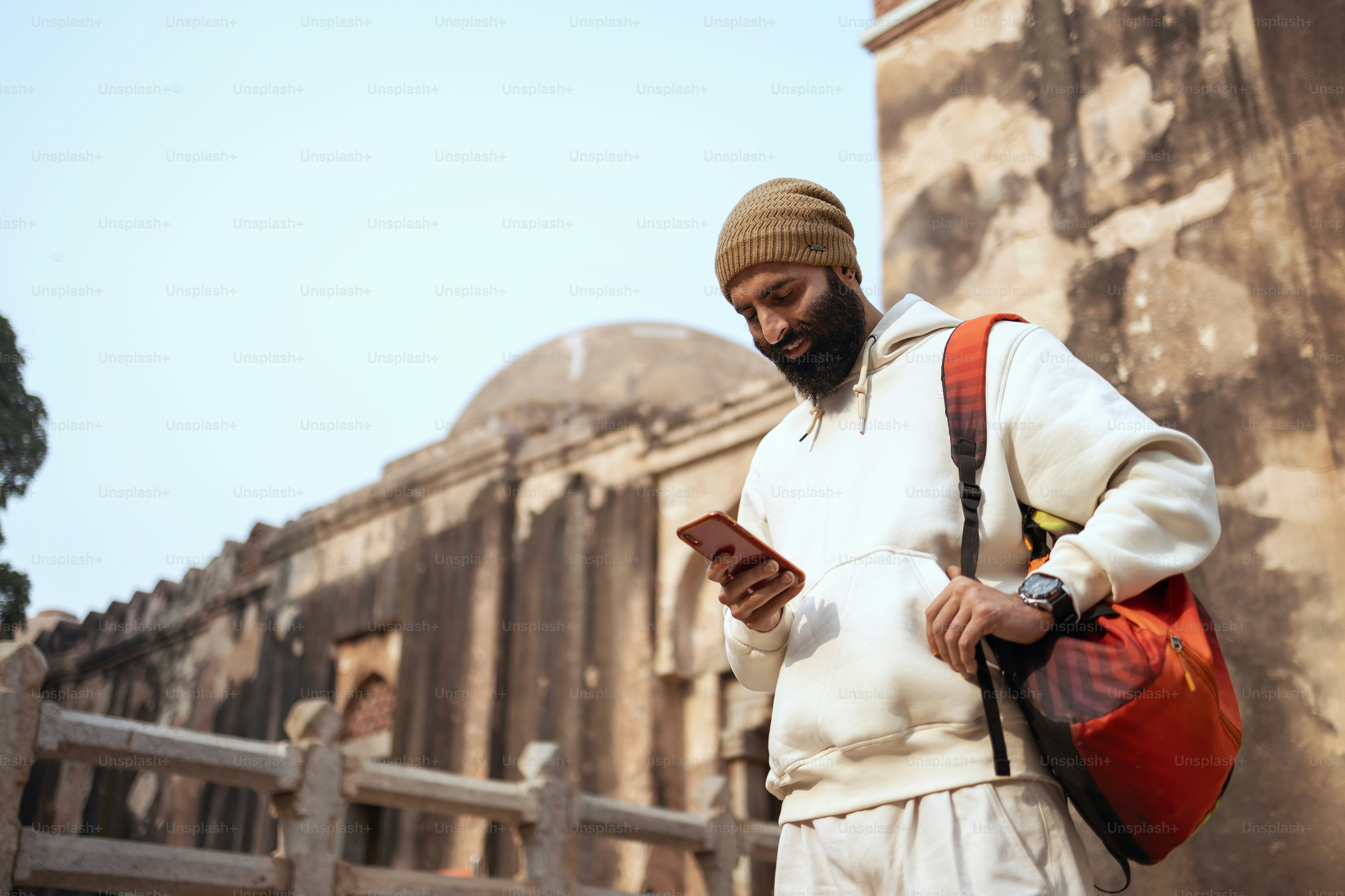 A man in a turban looking at his cell phone