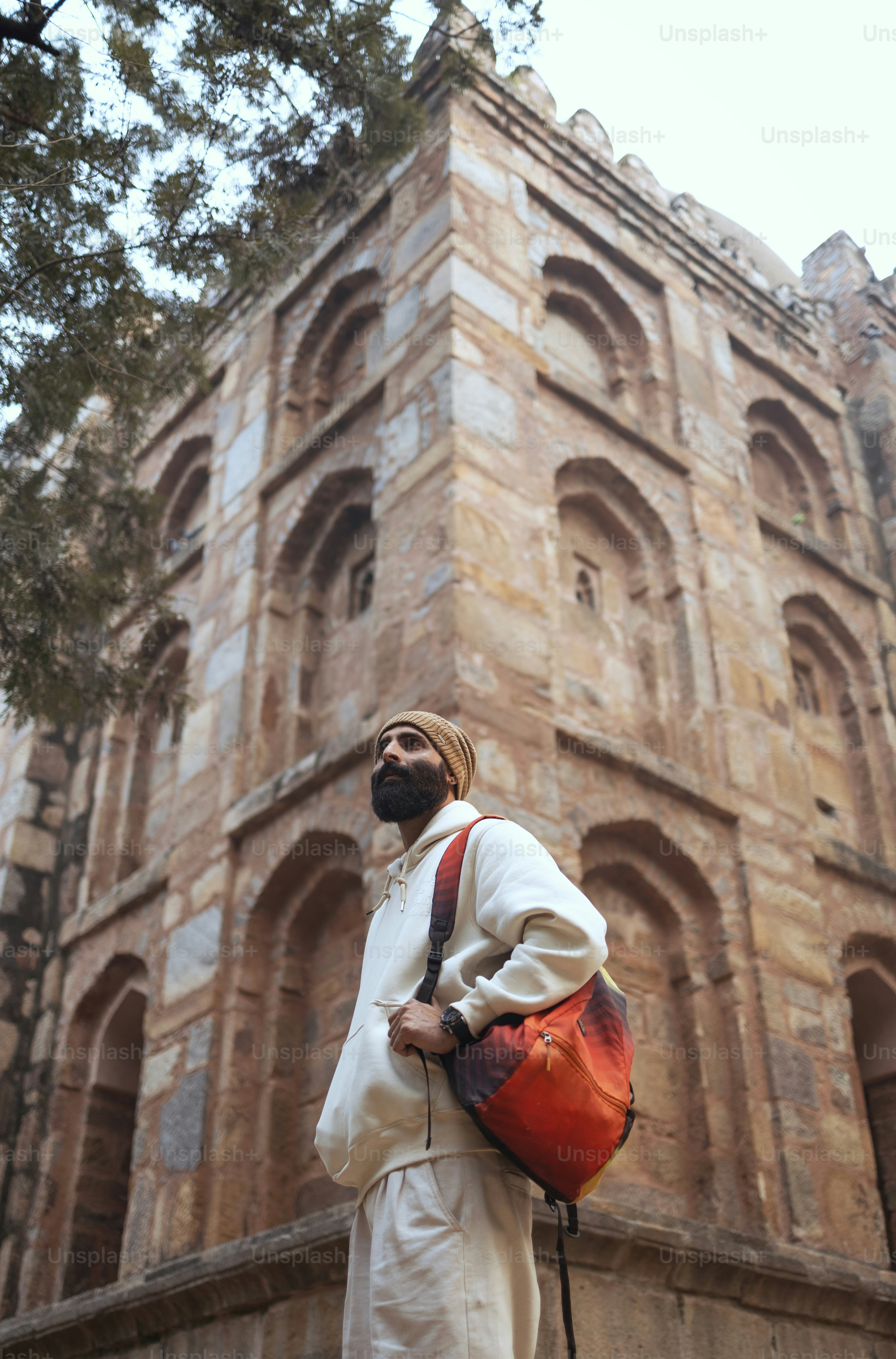 A man standing in front of a tall building