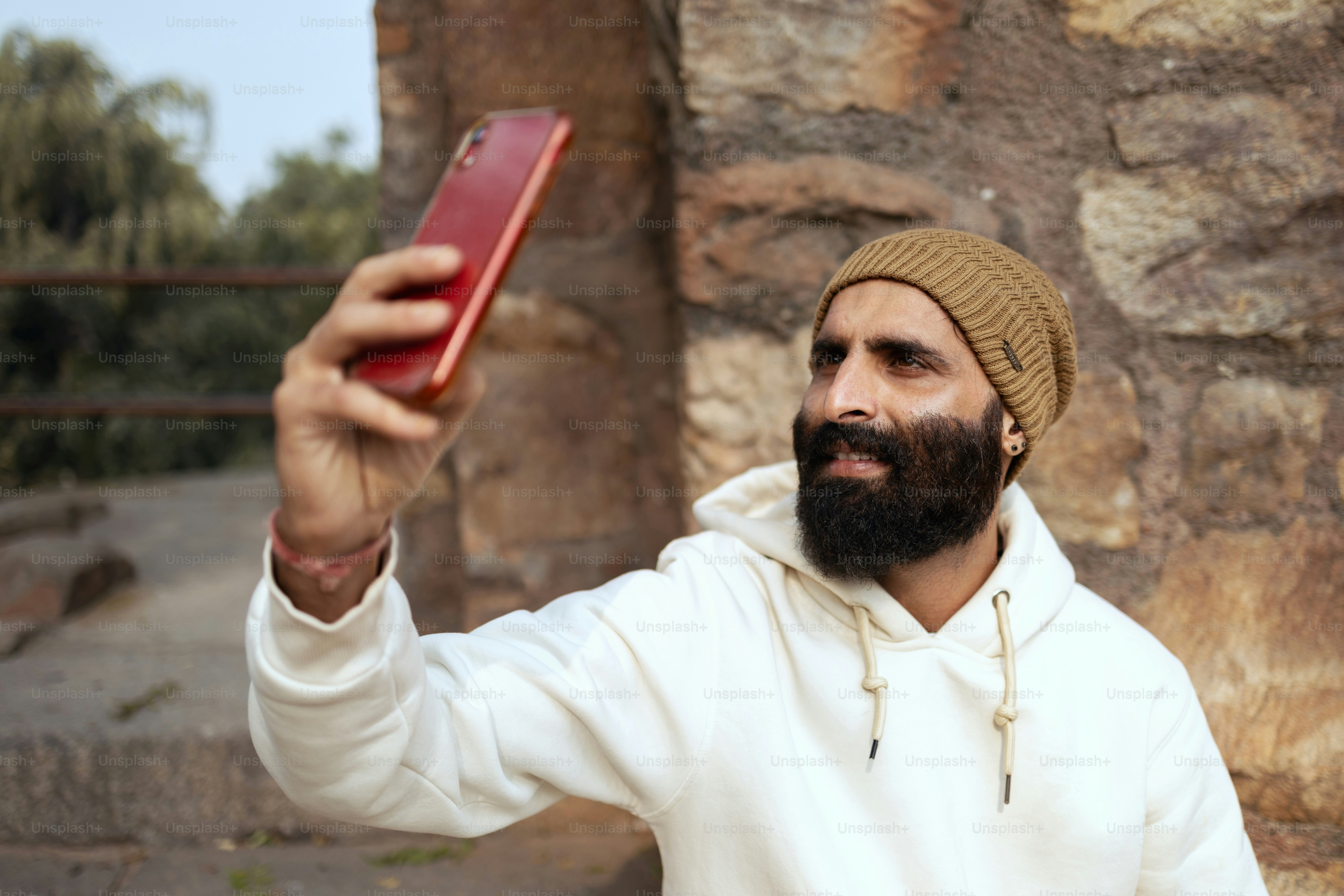 A man taking a selfie with a cell phone
