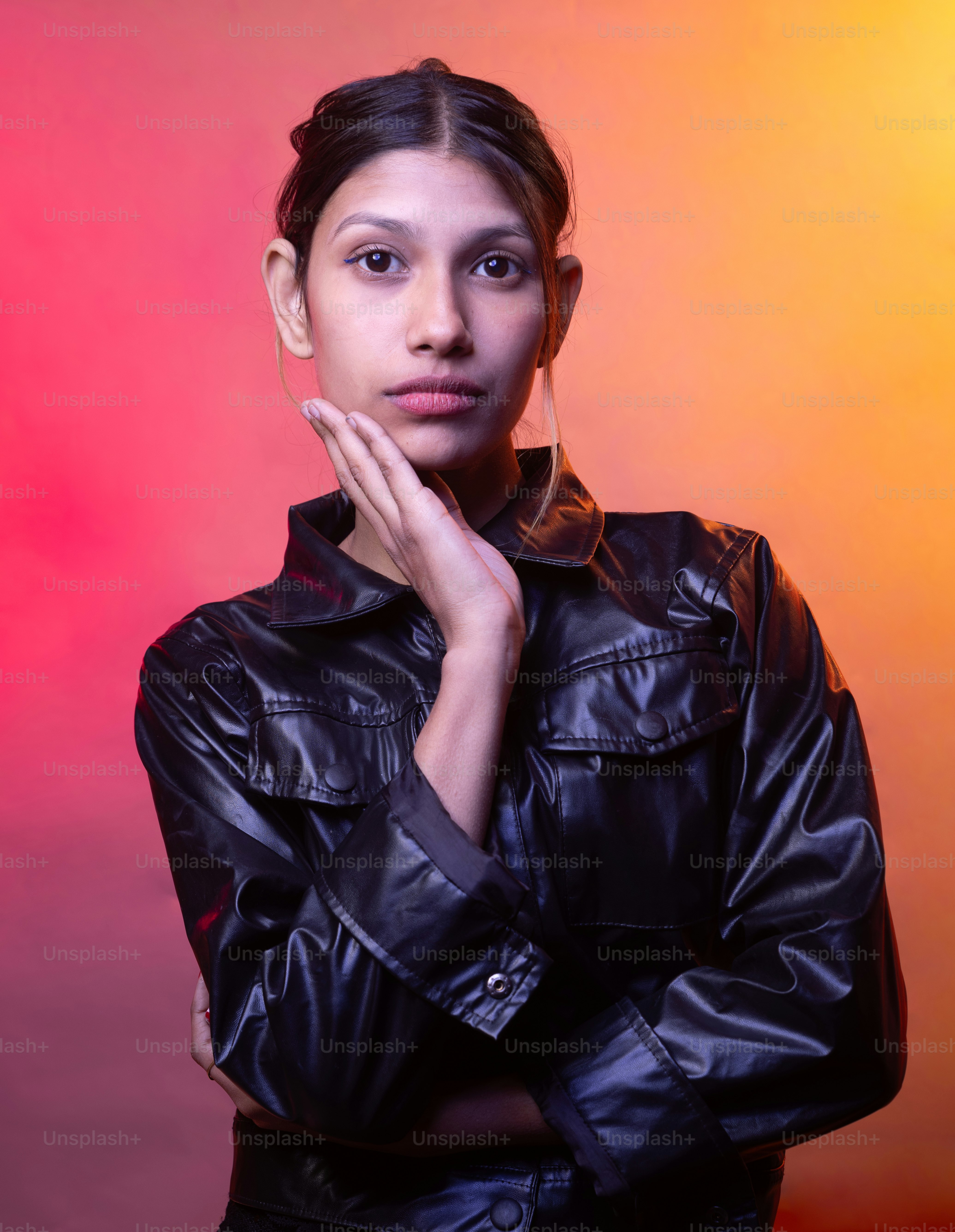 A woman in a black leather jacket posing for a picture photo – Portrait ...