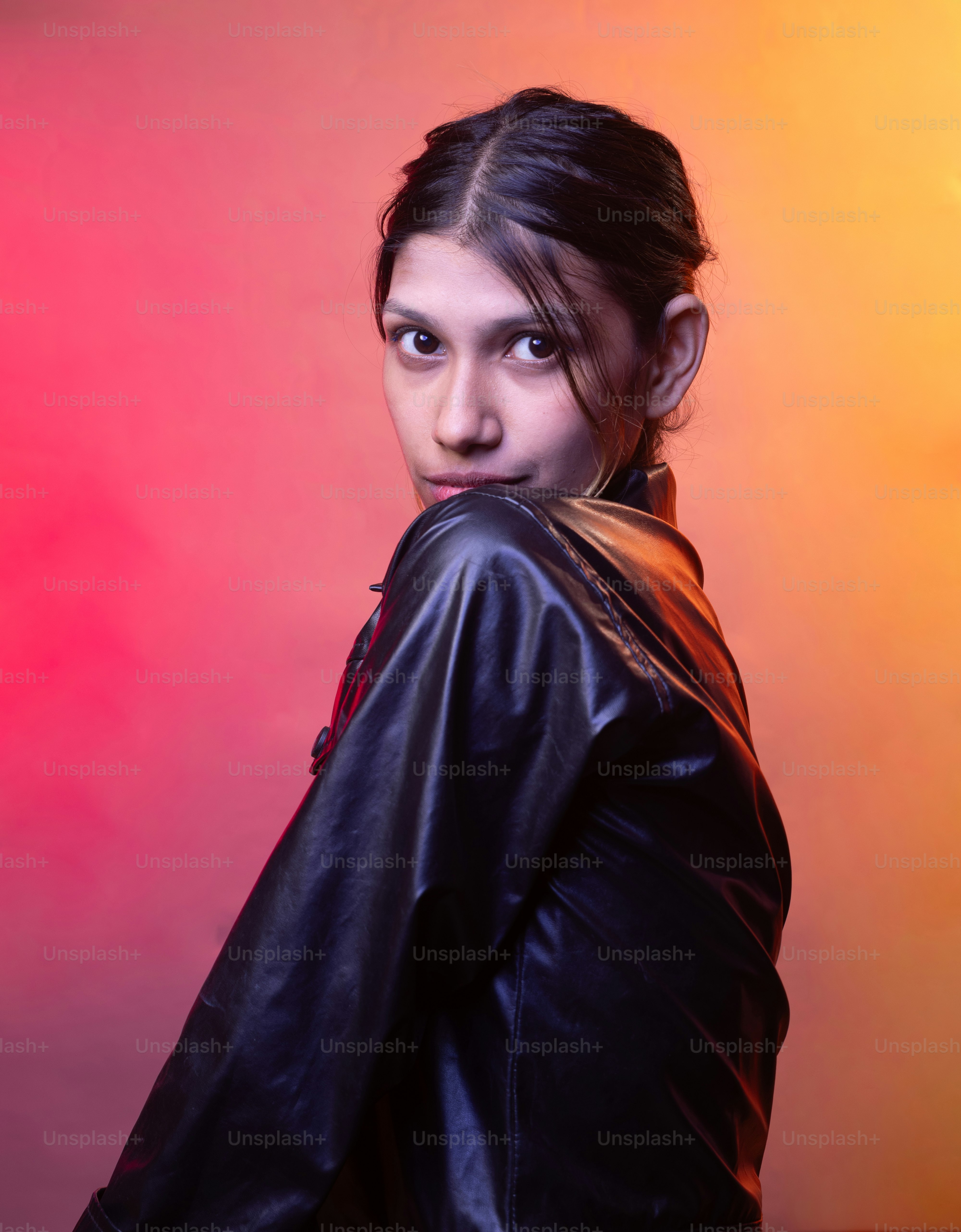 A woman in a leather jacket posing for a picture photo – Portrait Image ...