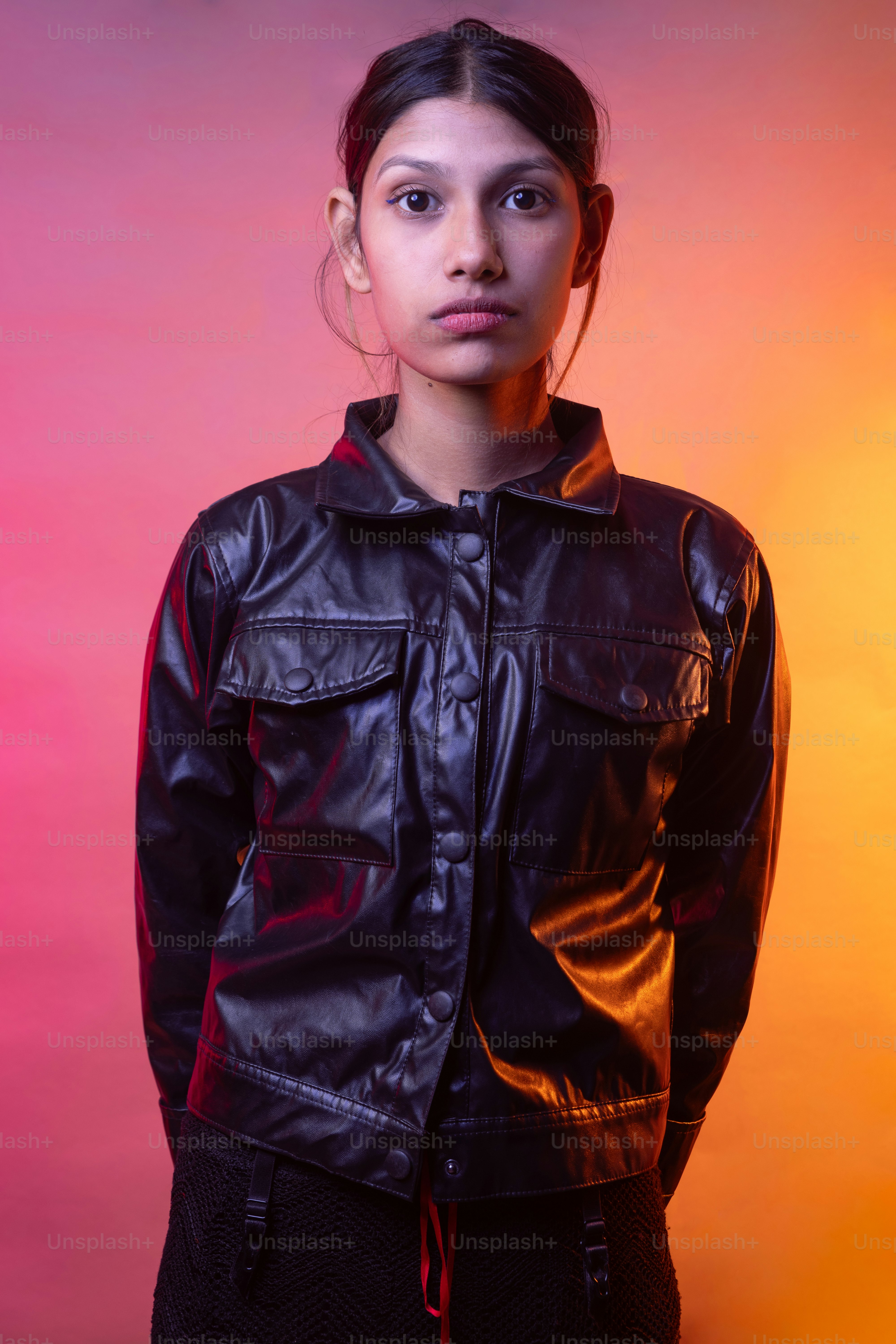 A woman in a black leather jacket posing for a picture photo – Portrait ...