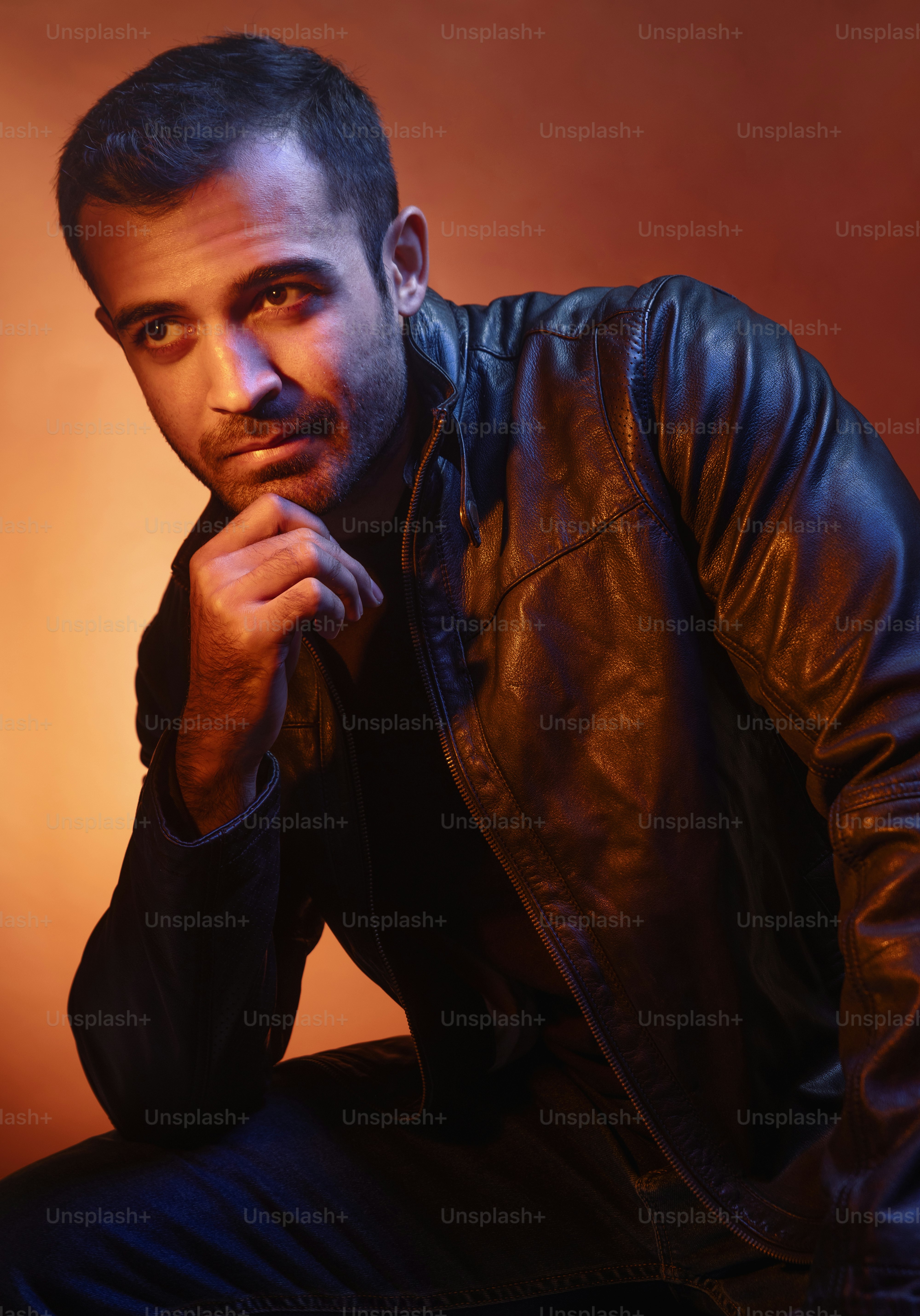 A man in a leather jacket posing for a picture photo – Portrait Image ...
