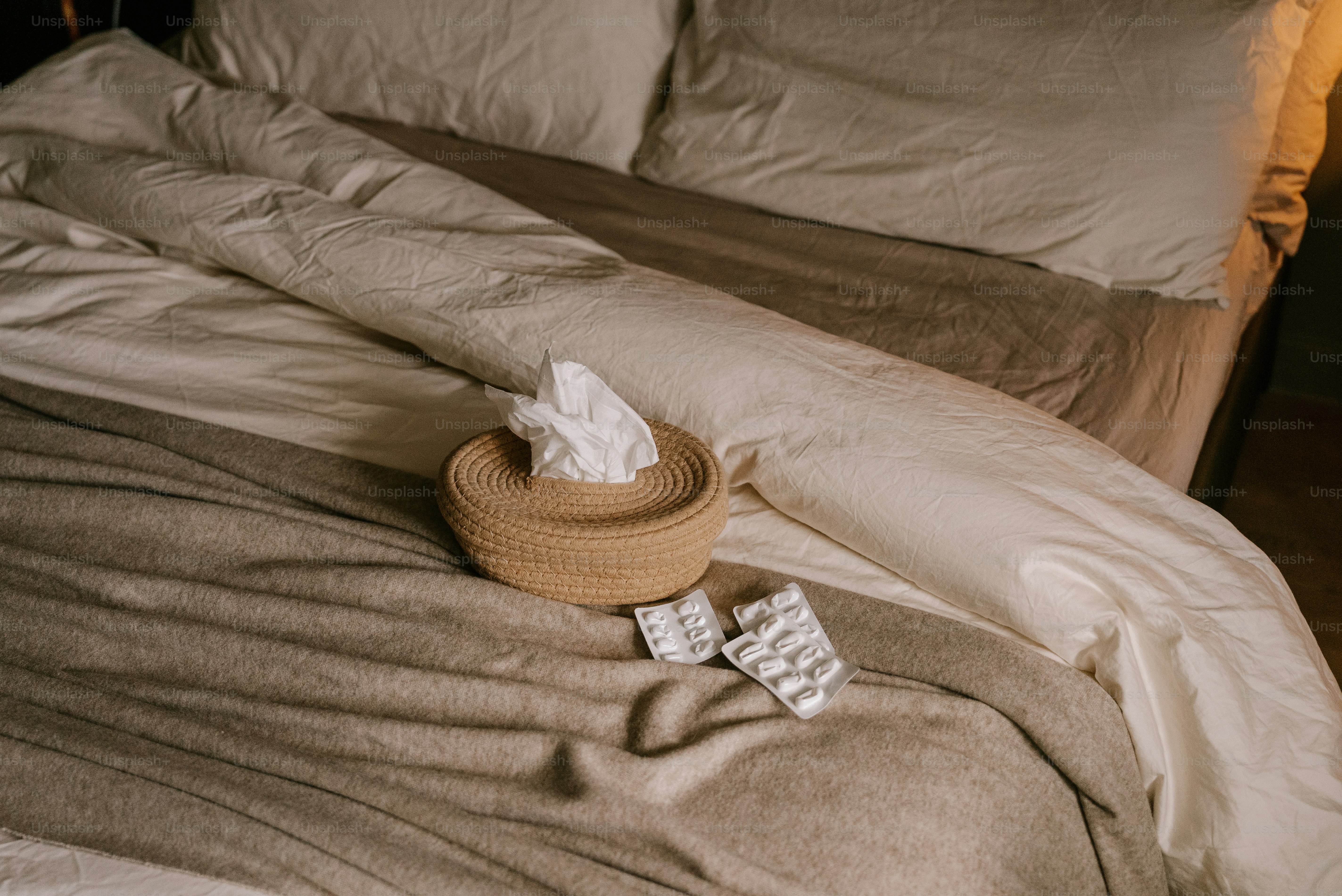 A bed with a wooden head board and pillows