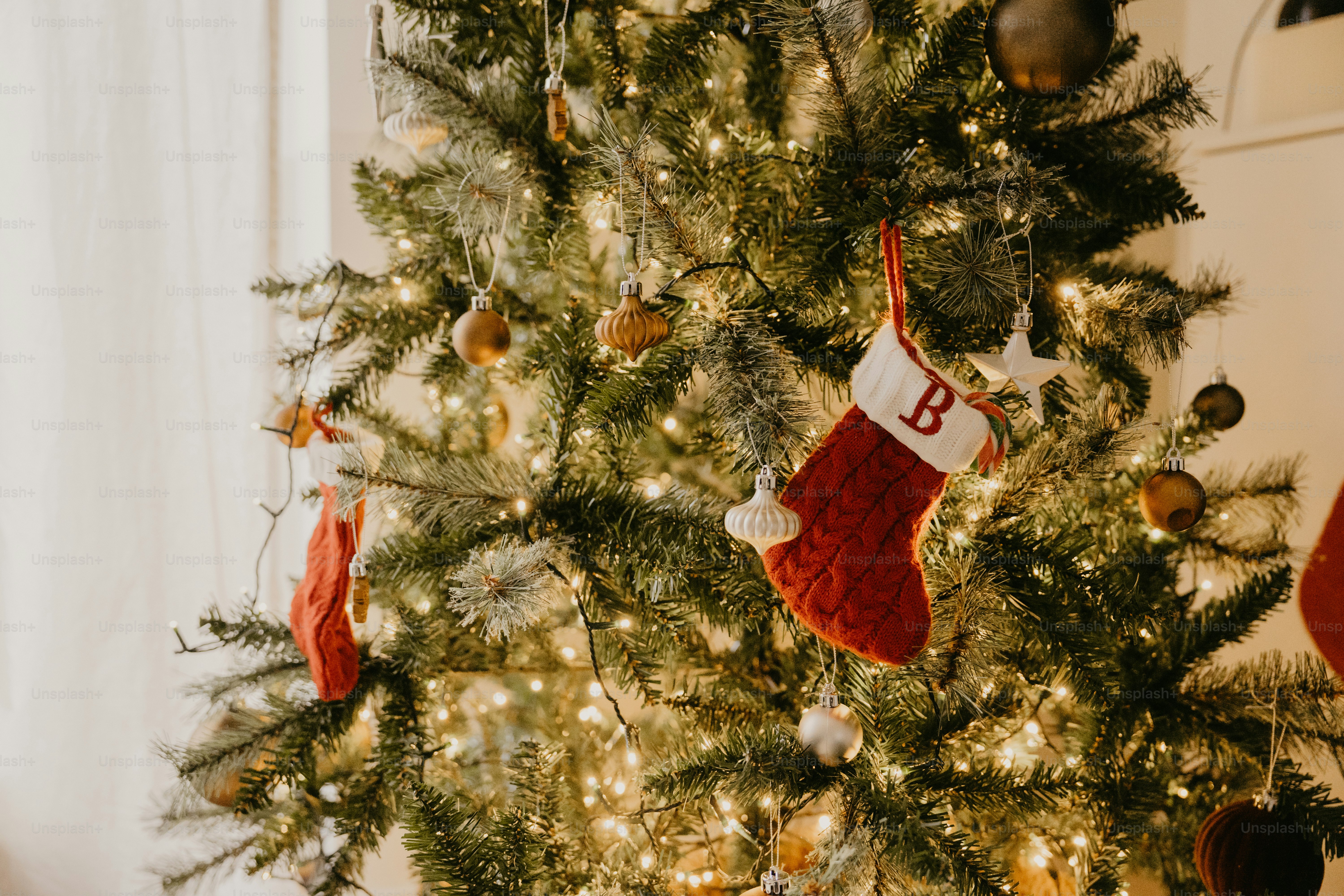 A christmas tree with stockings hanging from it