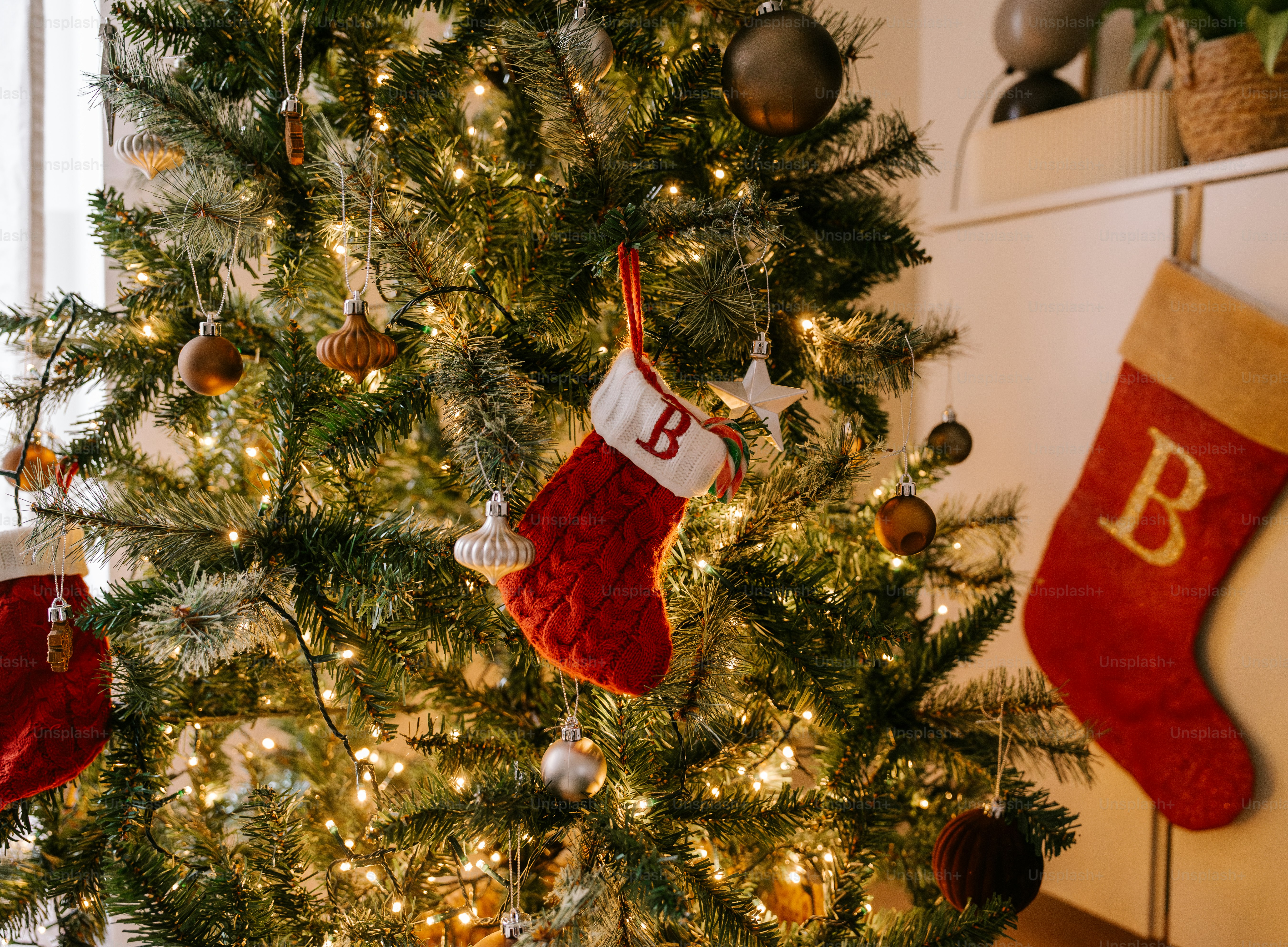 A christmas tree with stockings hanging from it