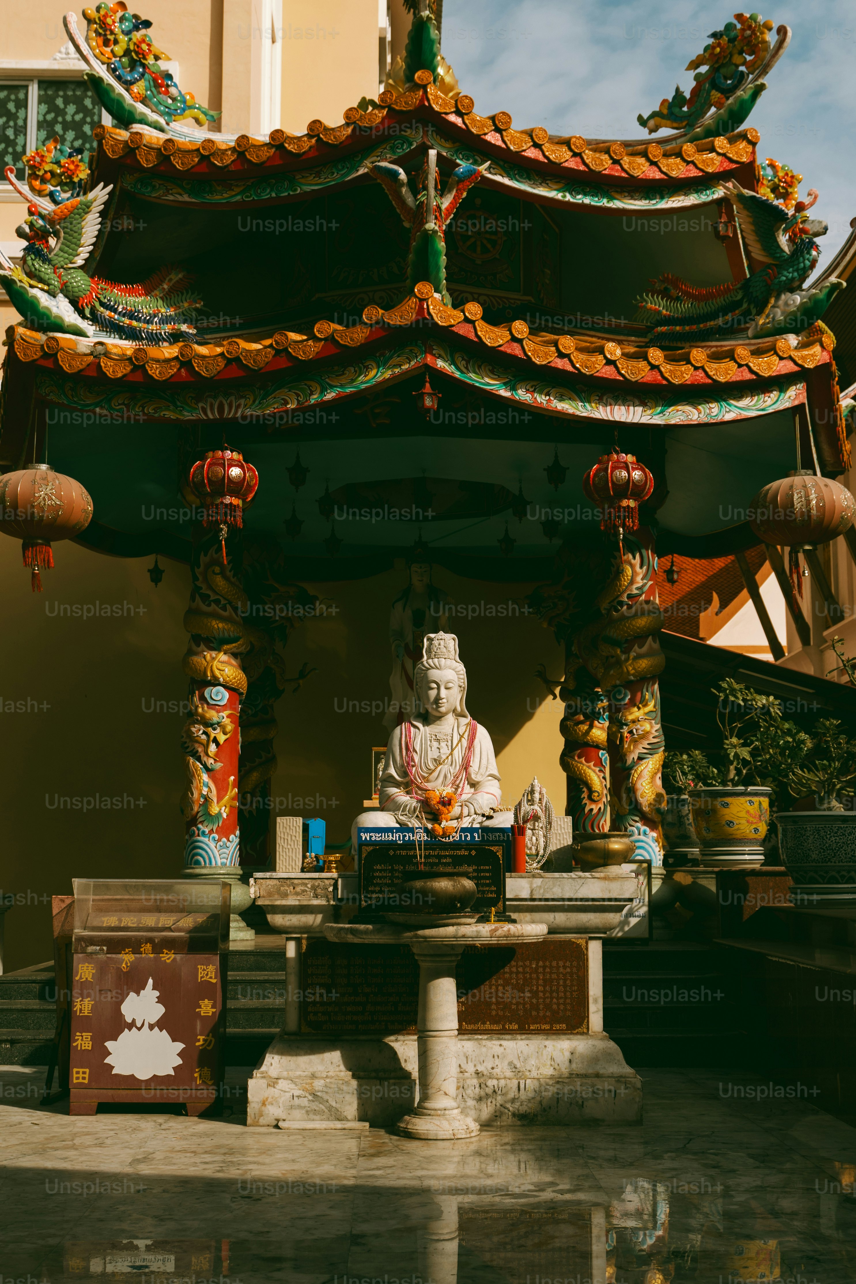 A statue of a buddha in front of a building