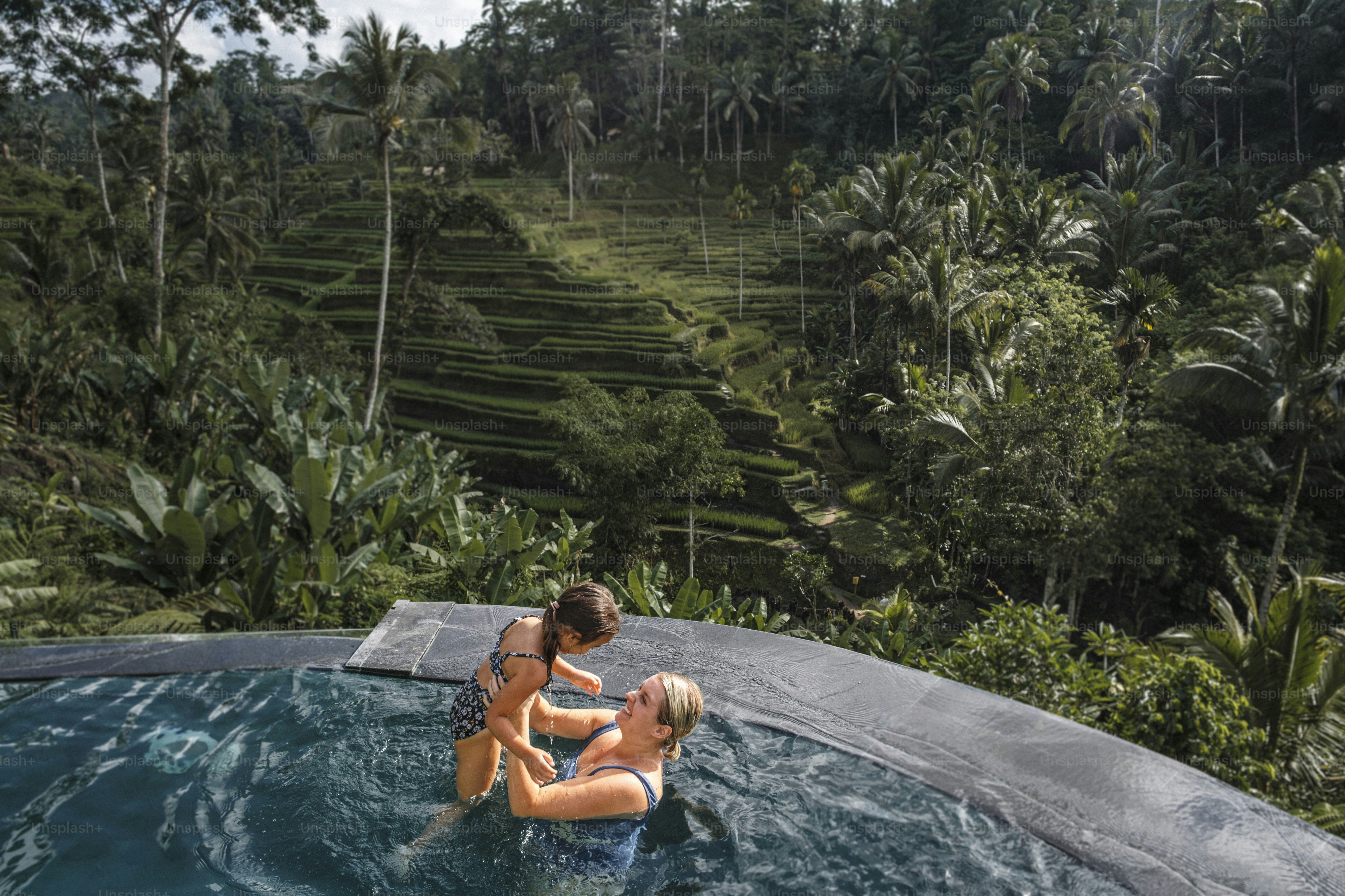 A woman in an inflatable pool in the jungle