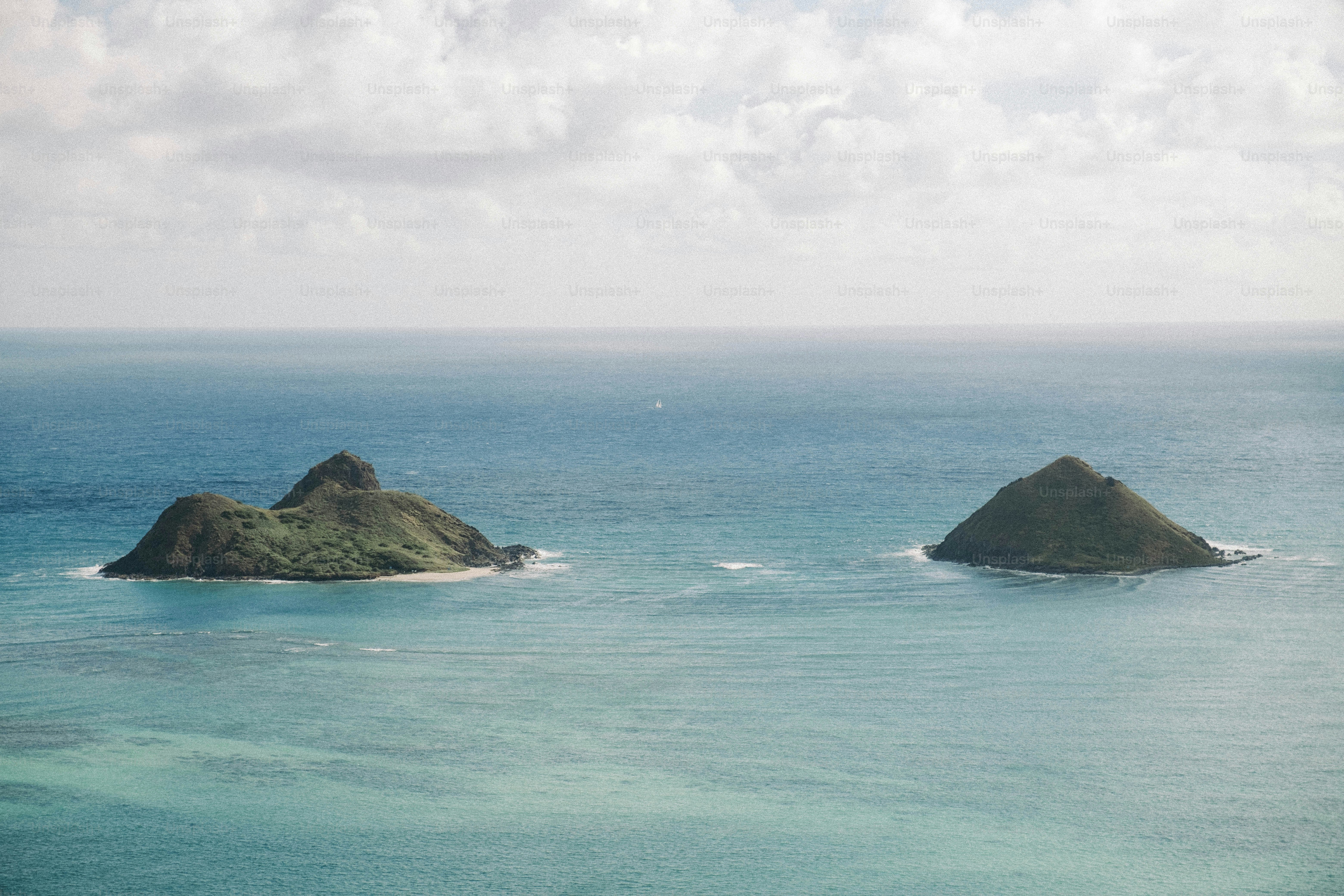 A couple of small islands in the middle of the ocean