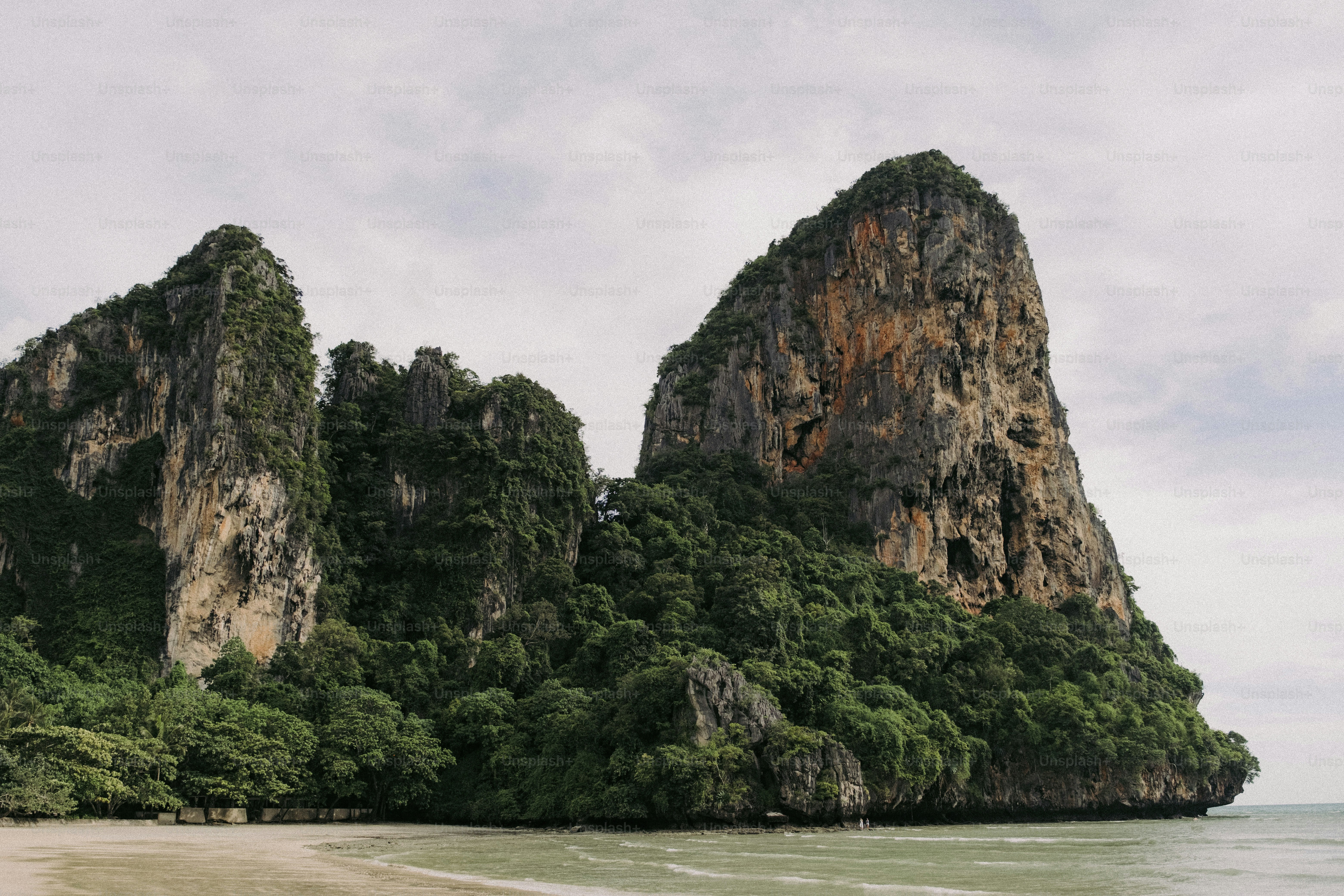 A group of rocks sitting on top of a sandy beach