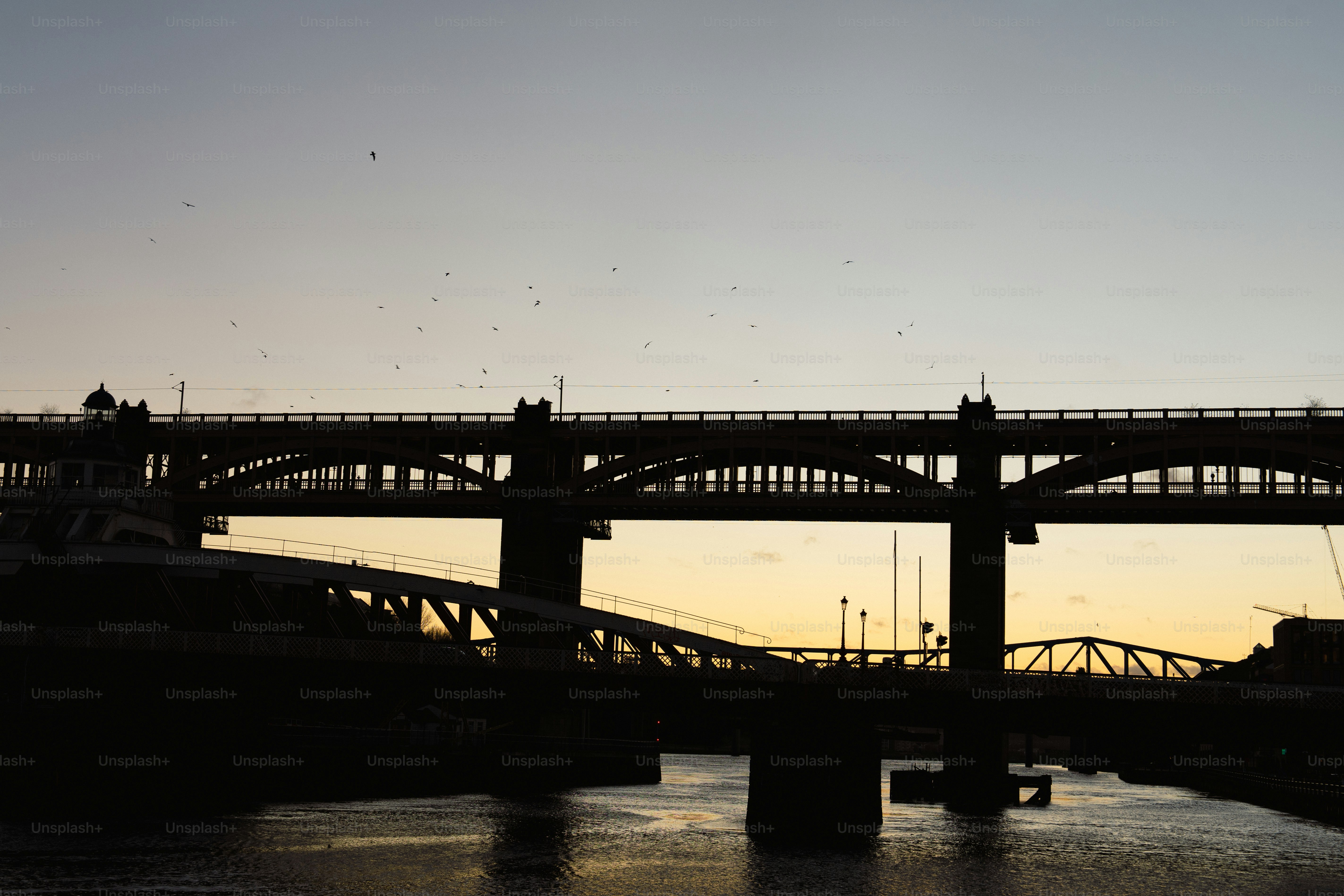 A bridge over a body of water at sunset
