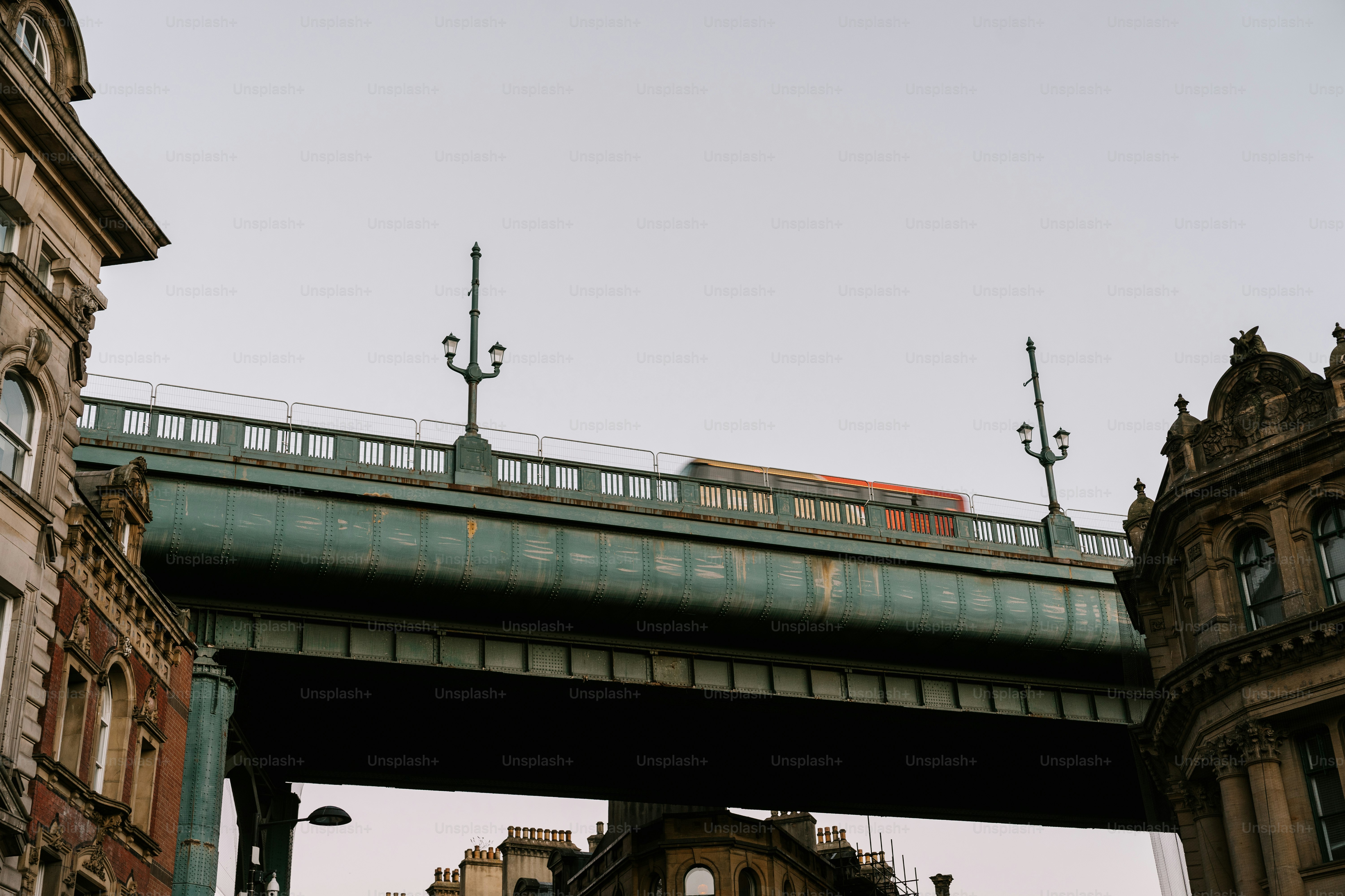 A bridge over a city street with tall buildings