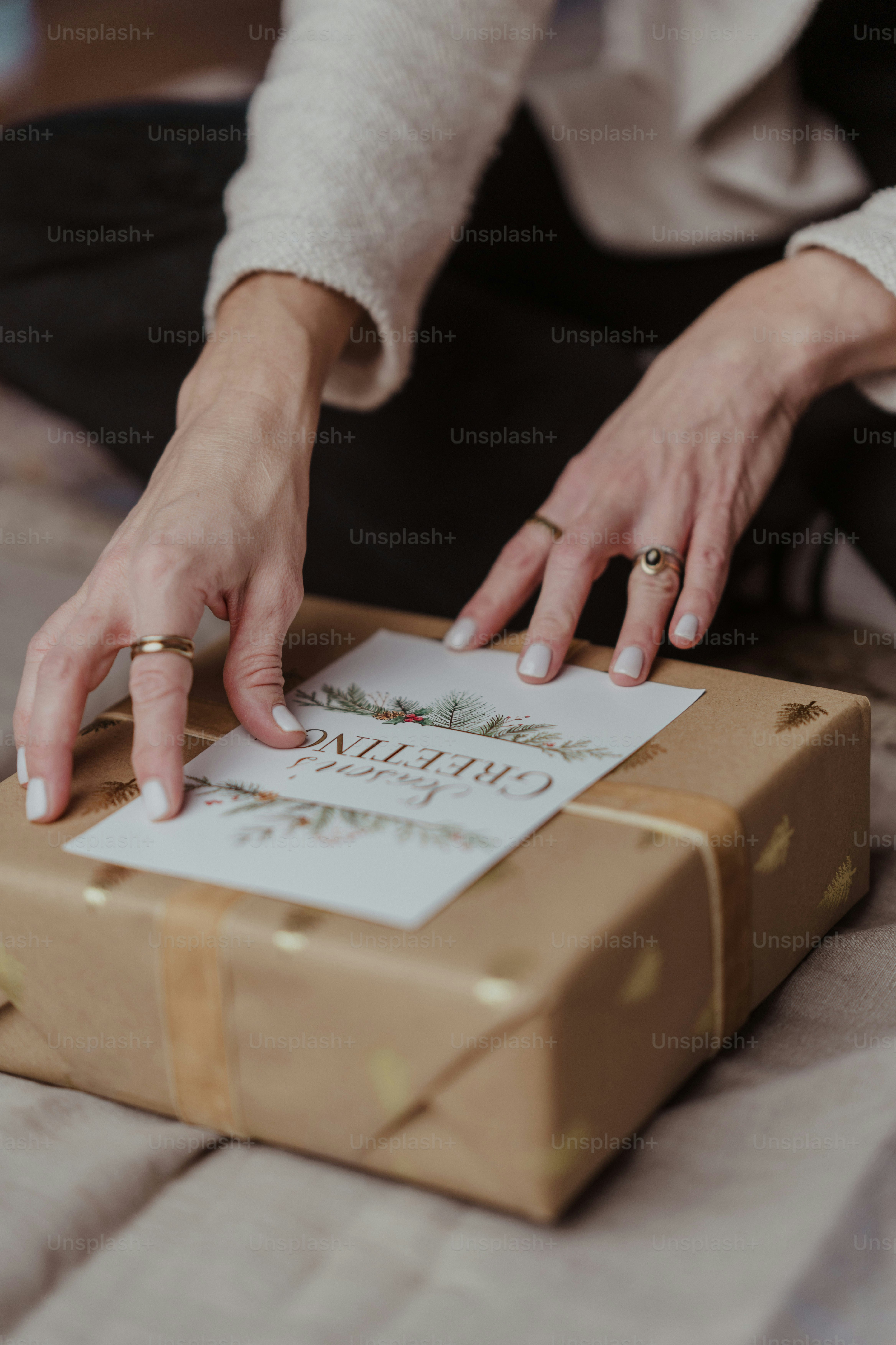 A woman putting a ring on a gift box