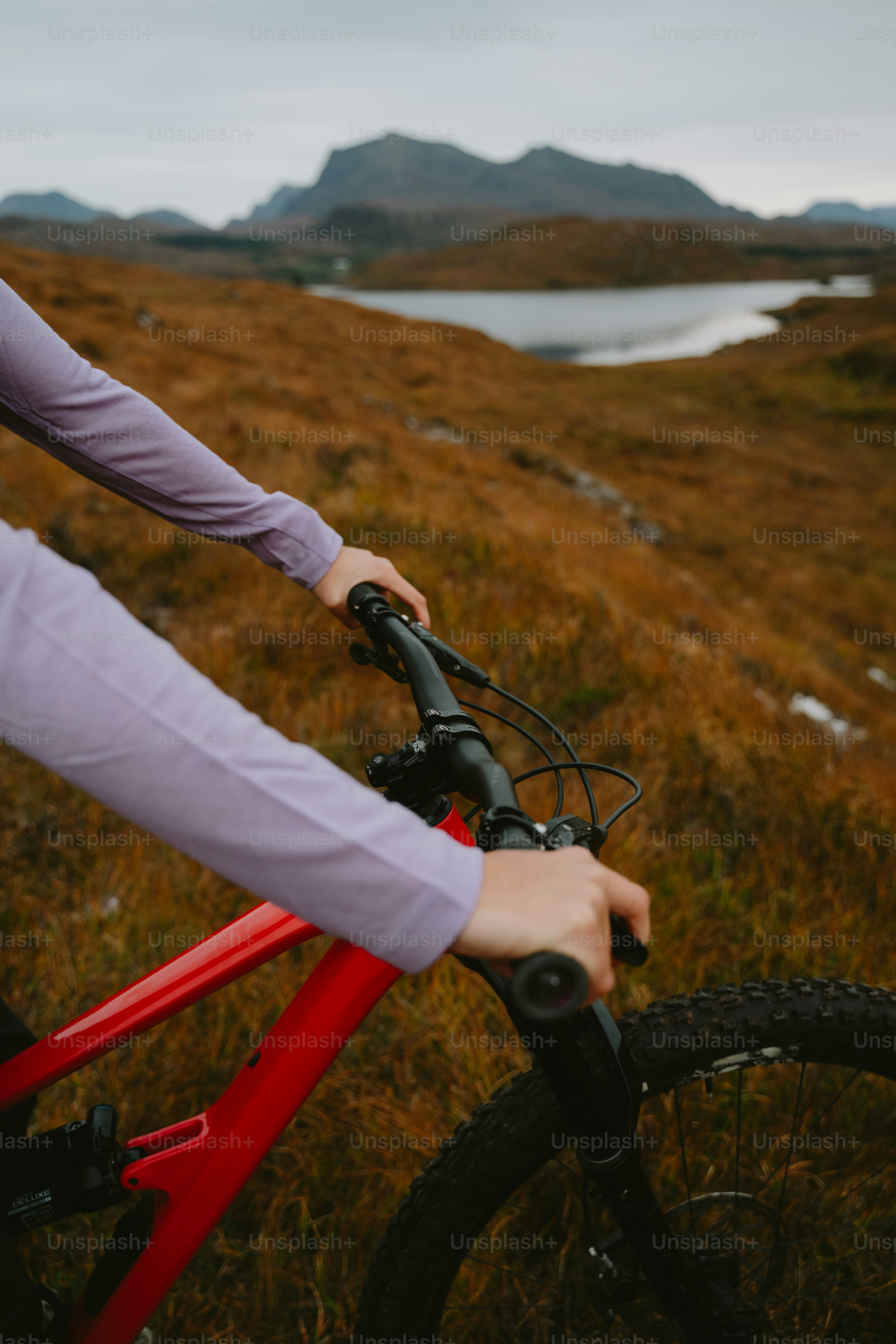 A person riding a bike on a grassy field