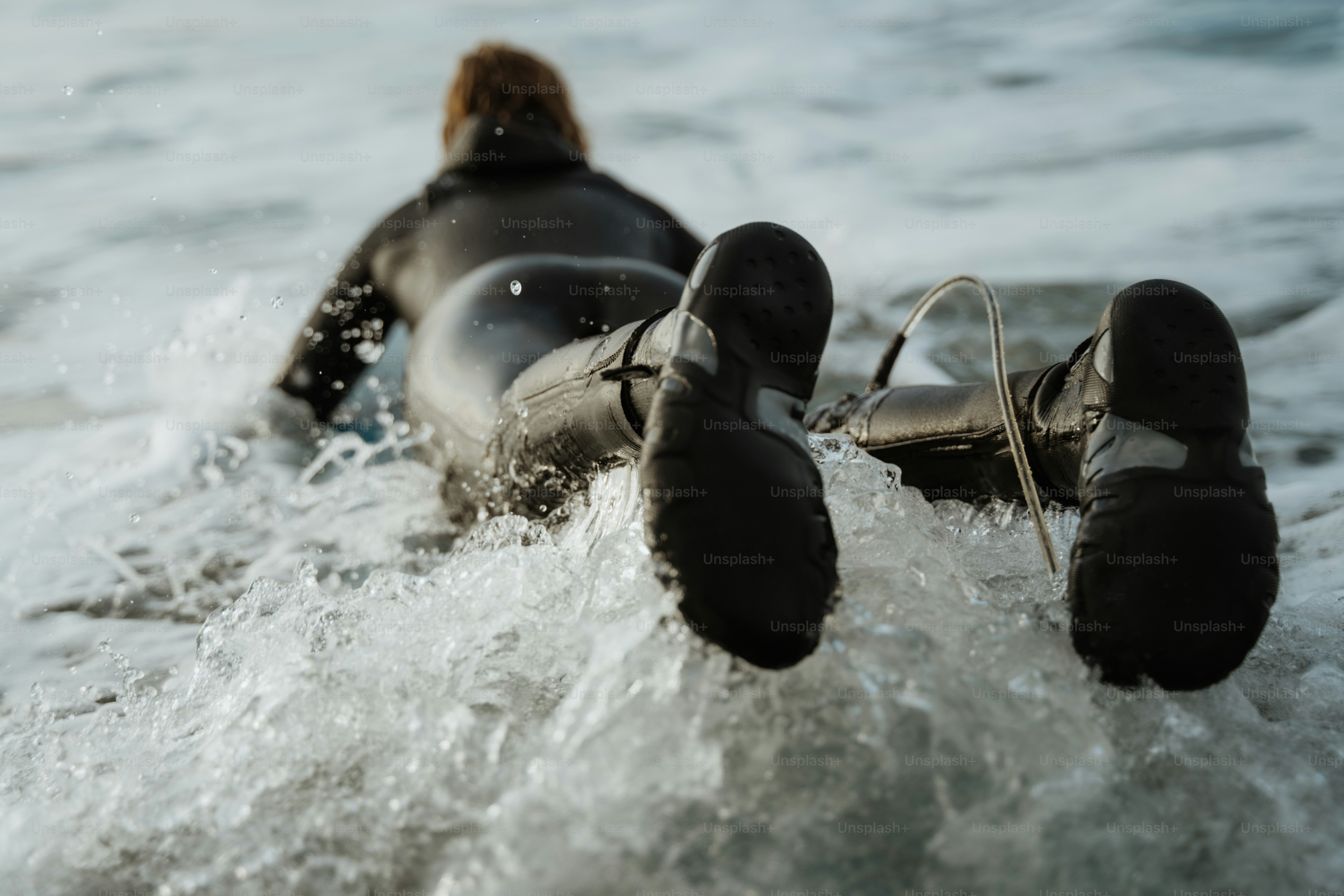 A person riding a surfboard on top of a wave