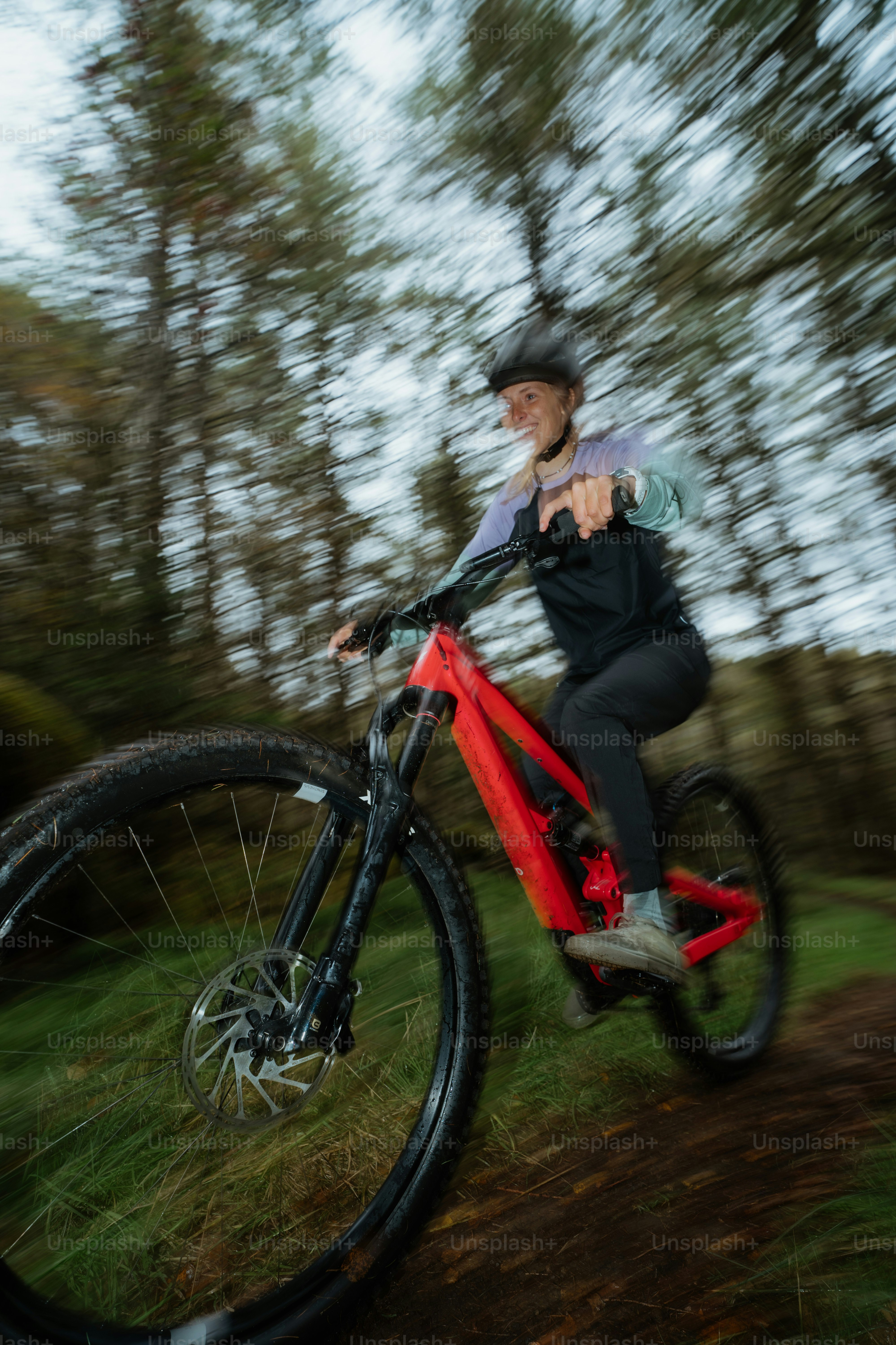 A man riding a bike down a dirt road