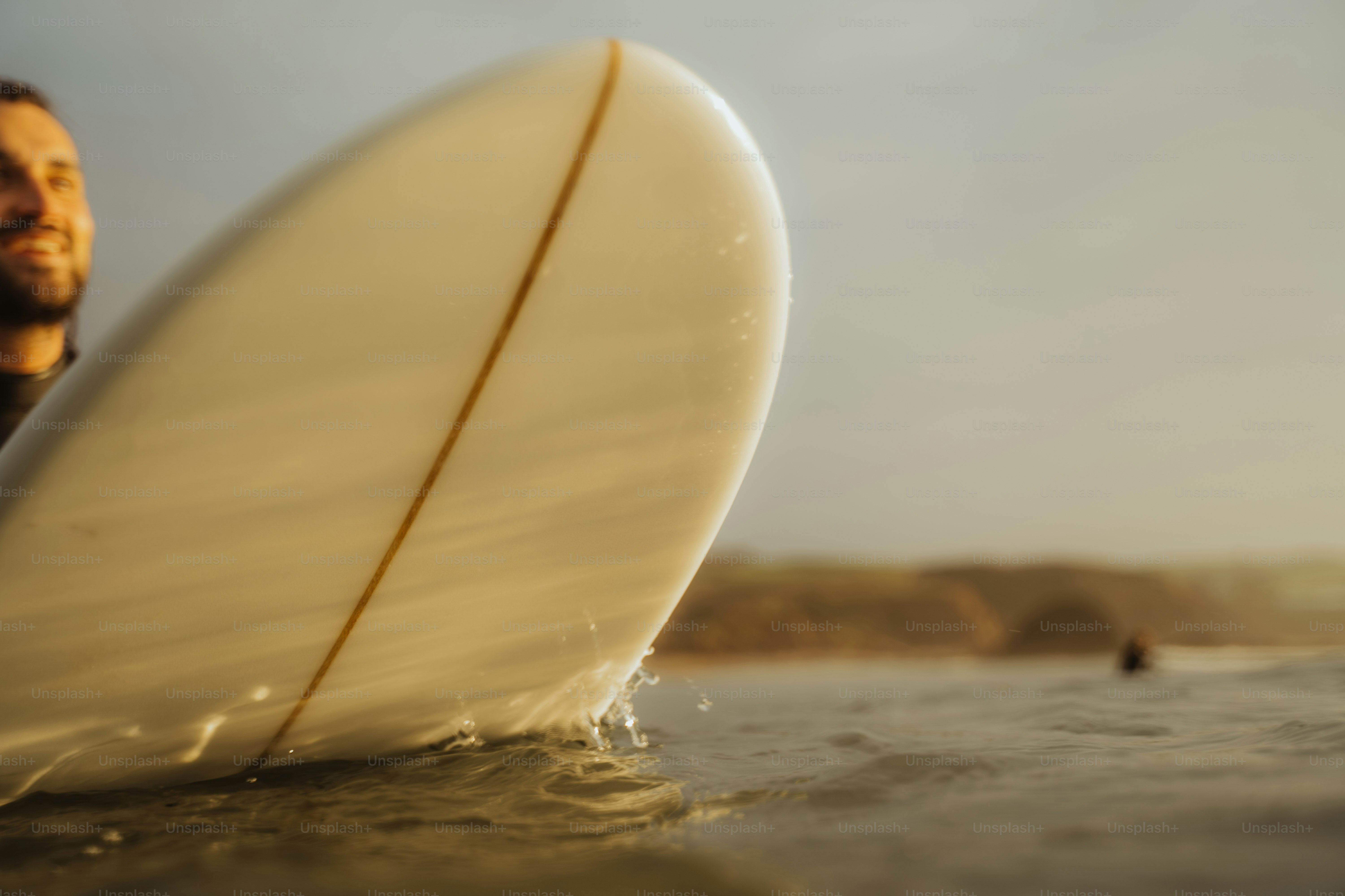 A man holding a surfboard in the water
