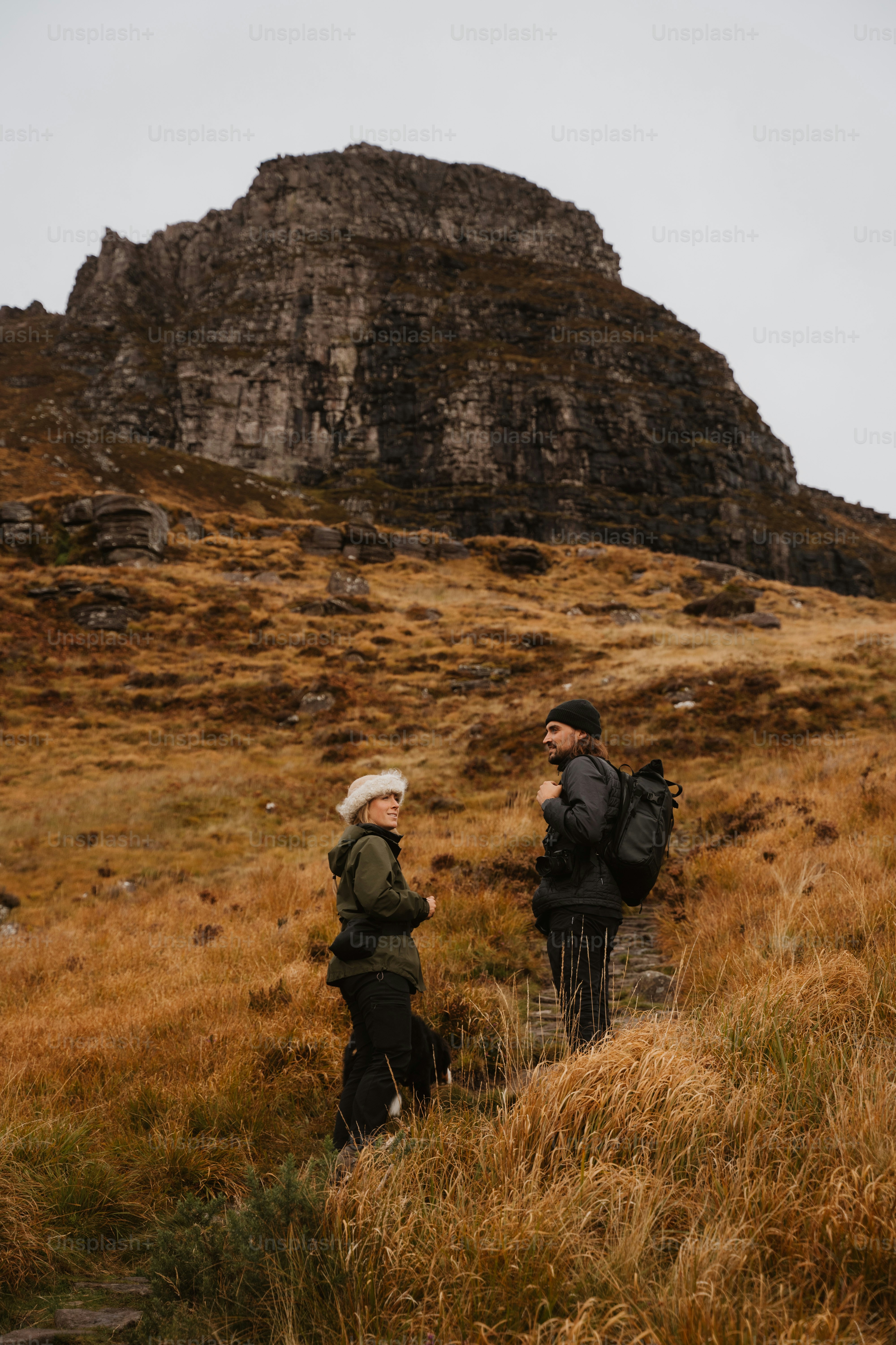A couple of people that are standing in the grass