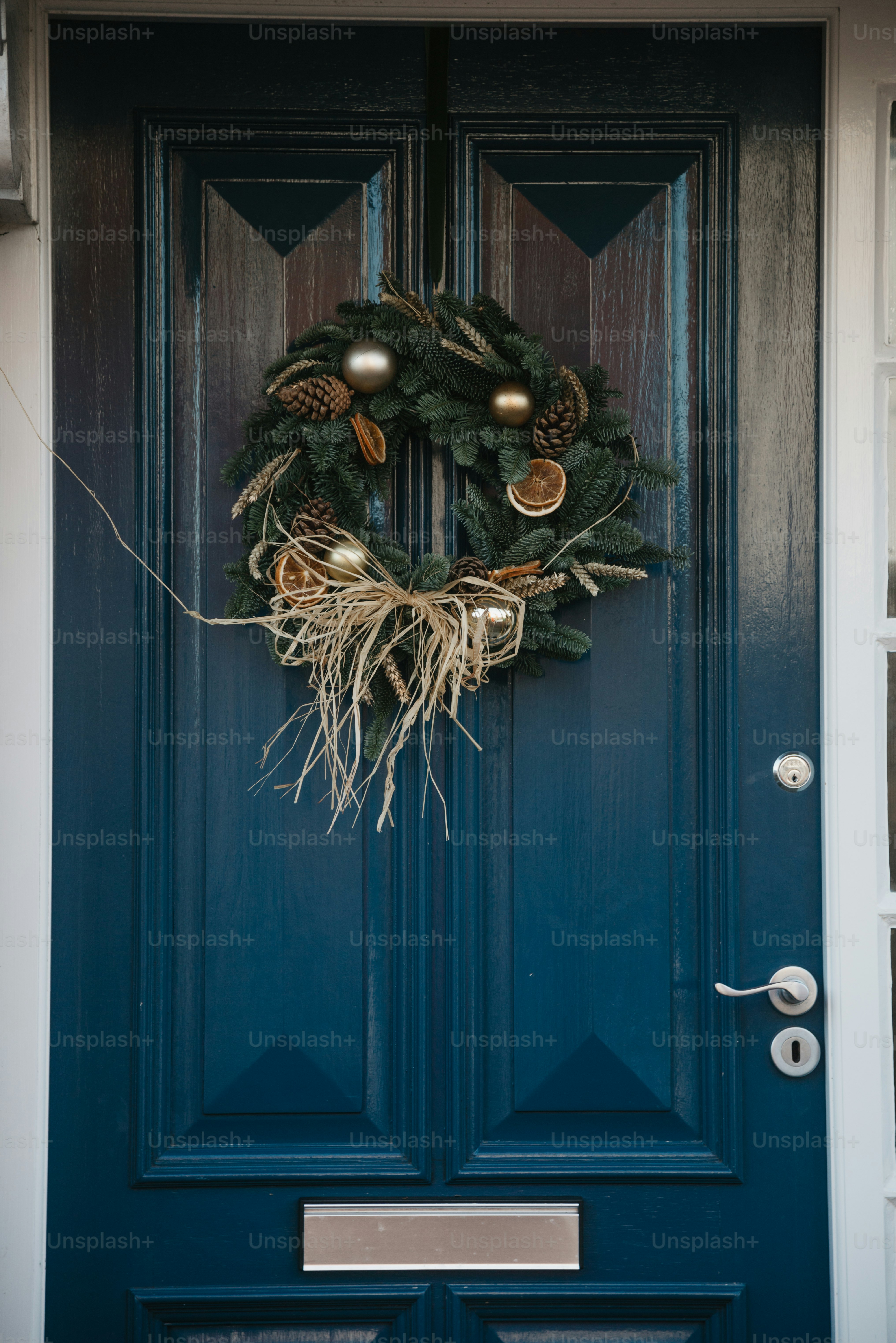 A blue front door with a wreath on it