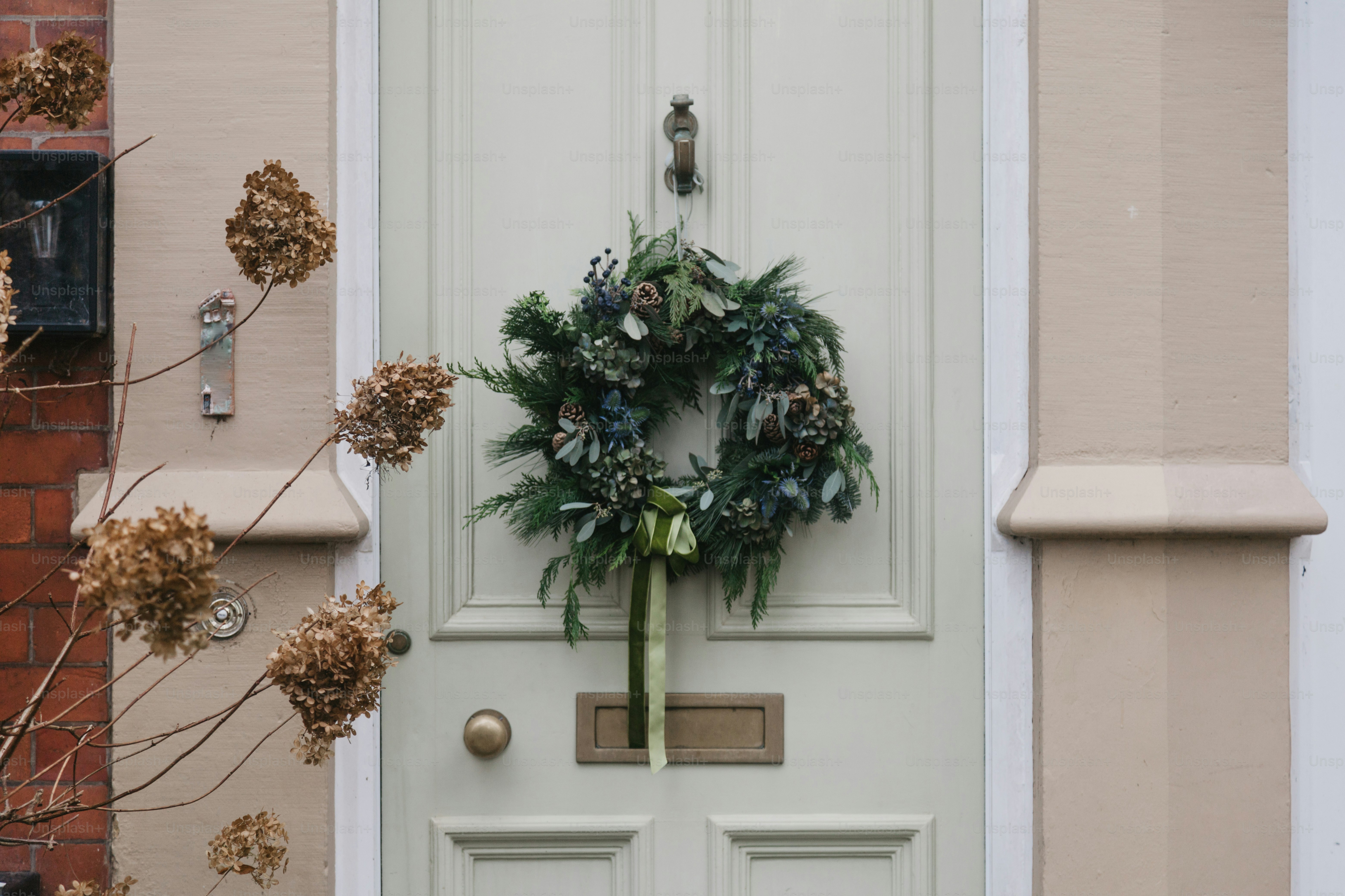 A white door with a wreath on it