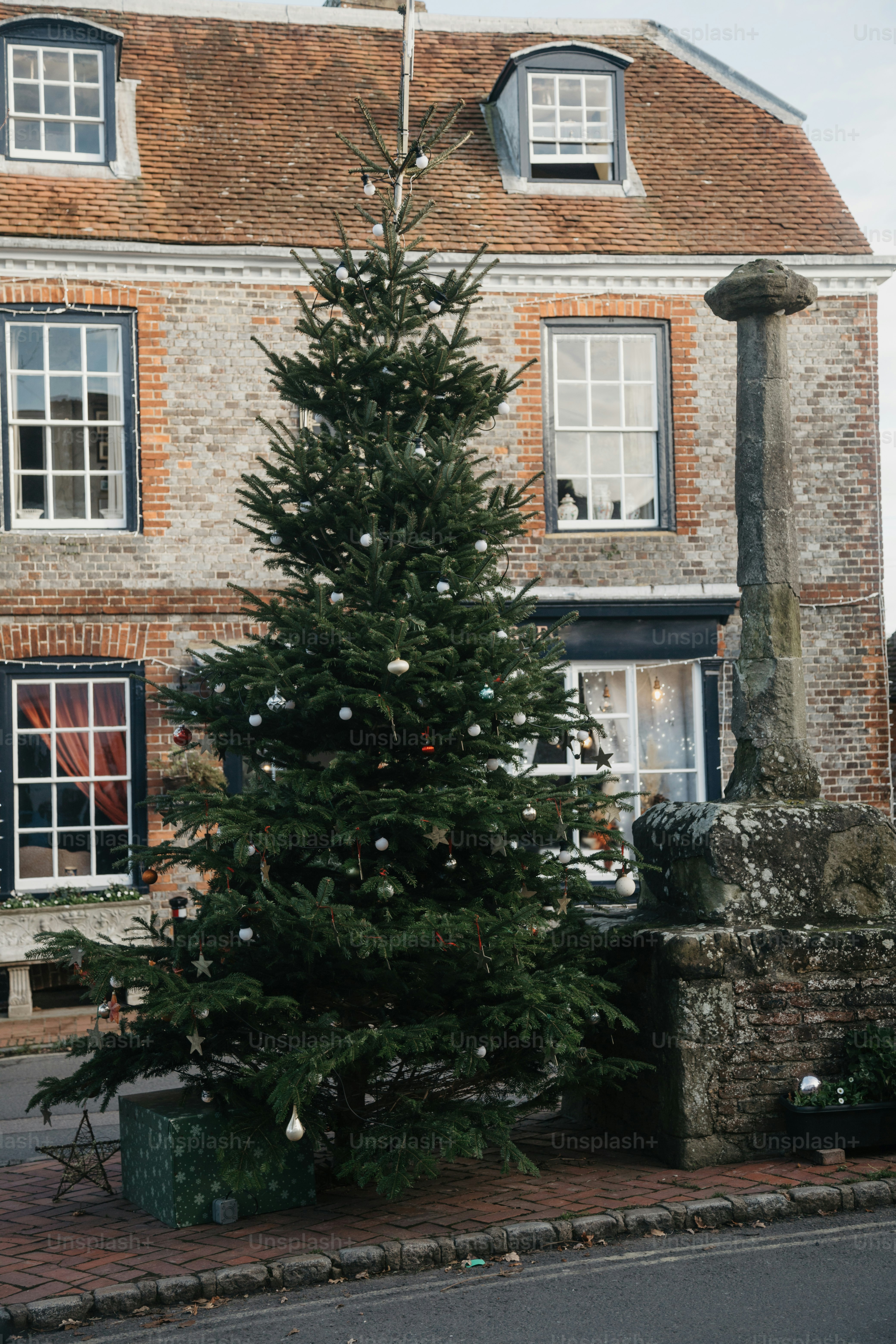 A large brick building with a christmas tree in front of it