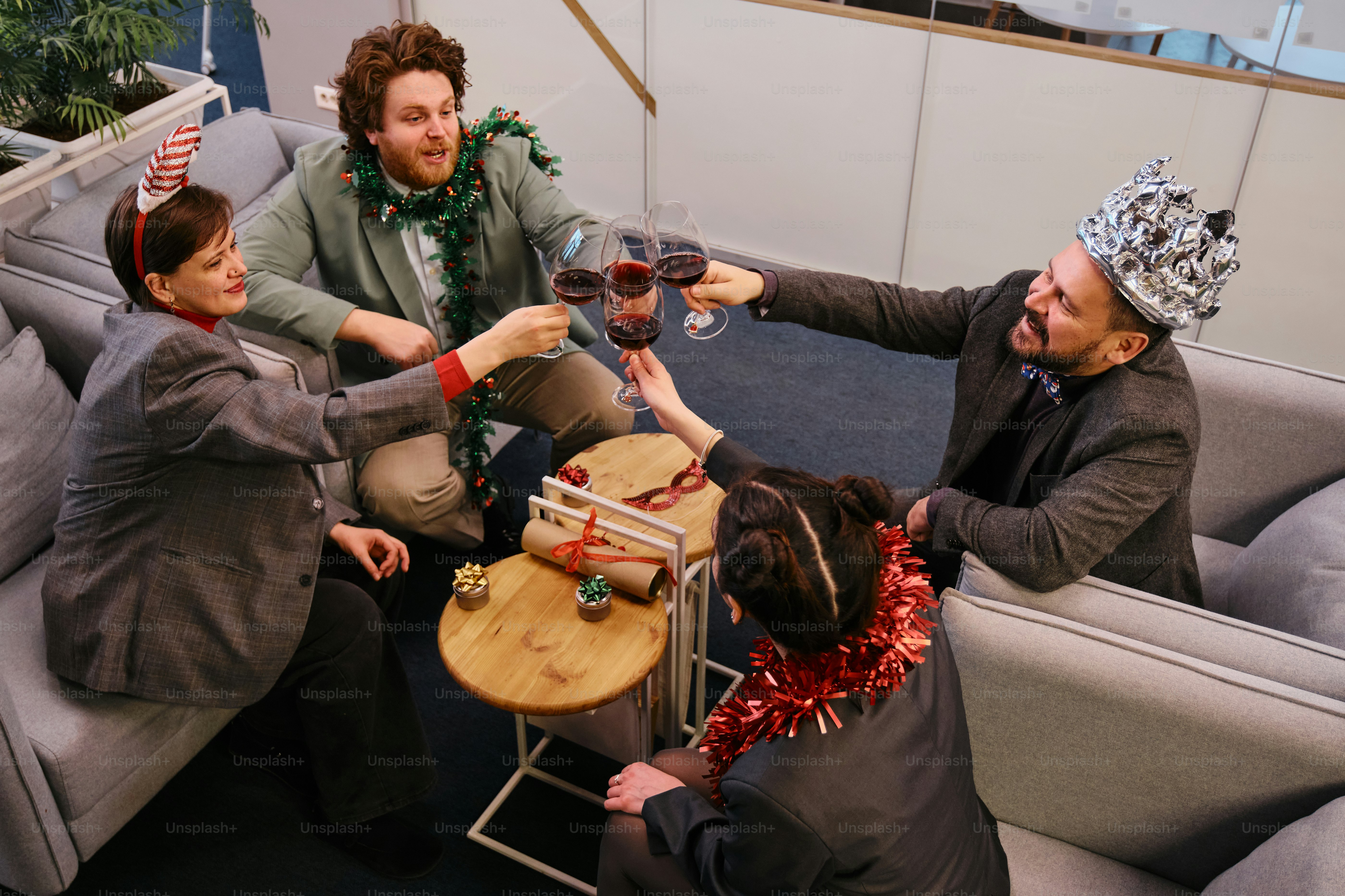 A group of people sitting on a couch drinking wine