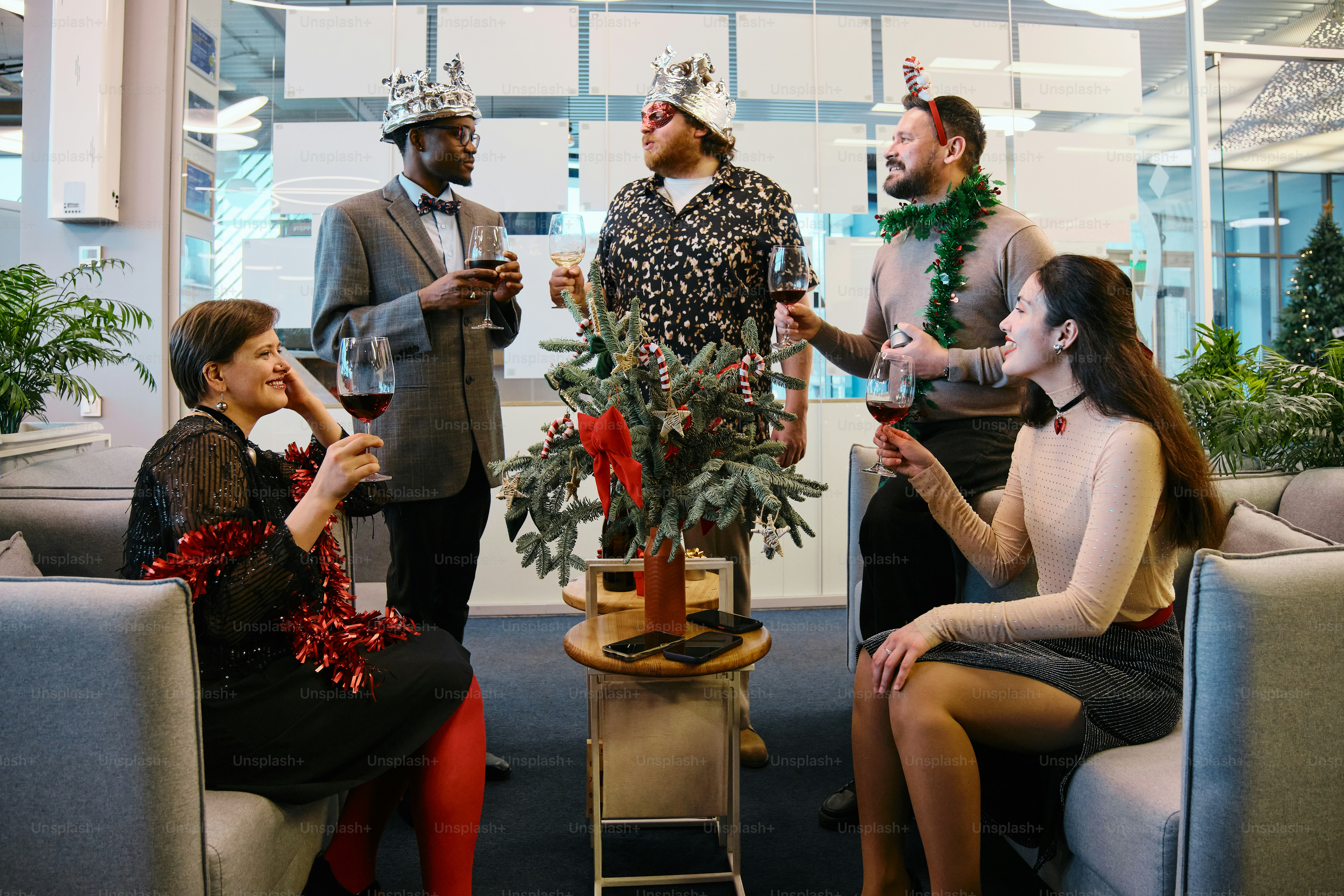 A group of people sitting around each other in a room