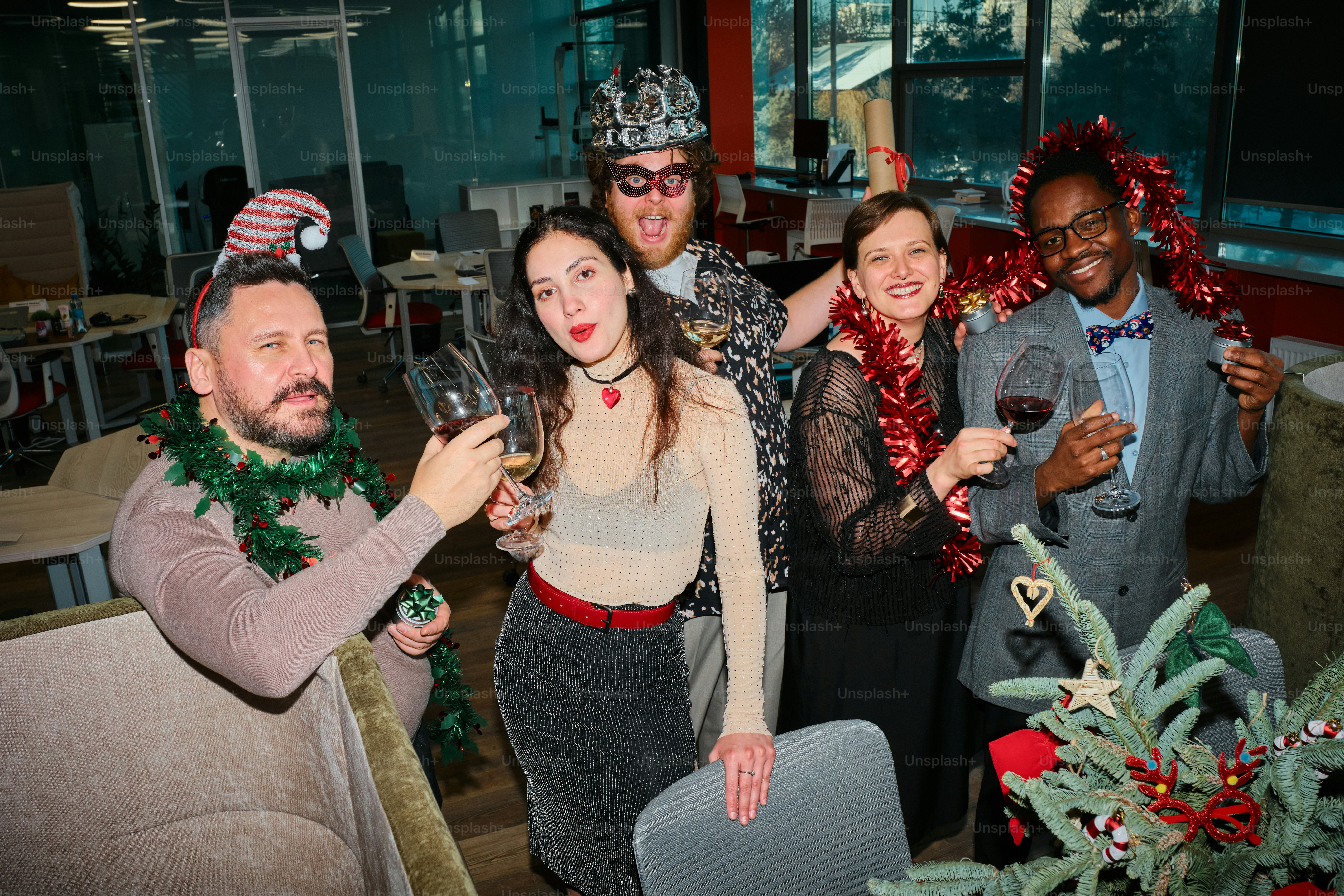 A group of people standing next to each other holding wine glasses