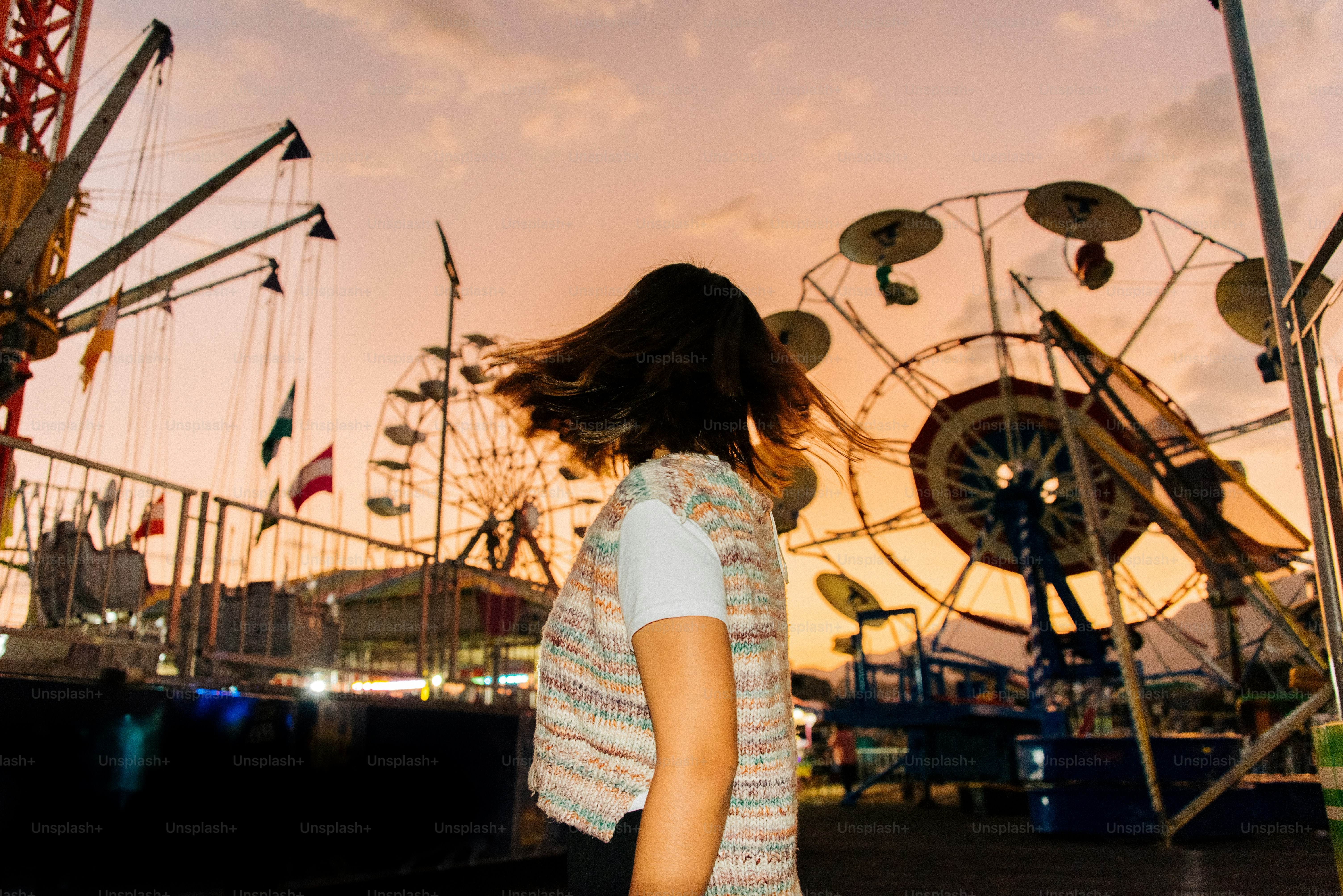 A woman standing in front of a ferris wheel