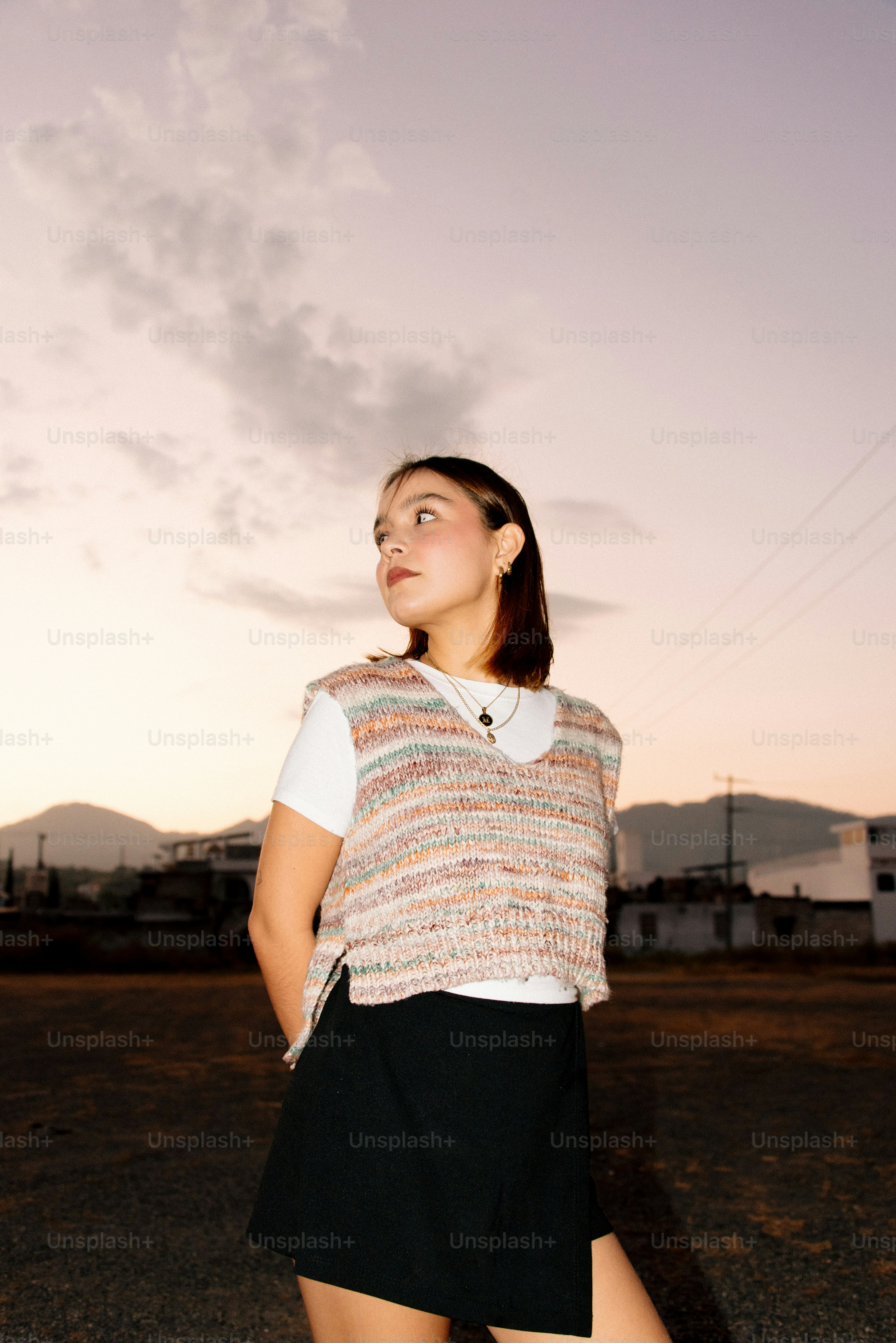 A woman standing in the middle of a road
