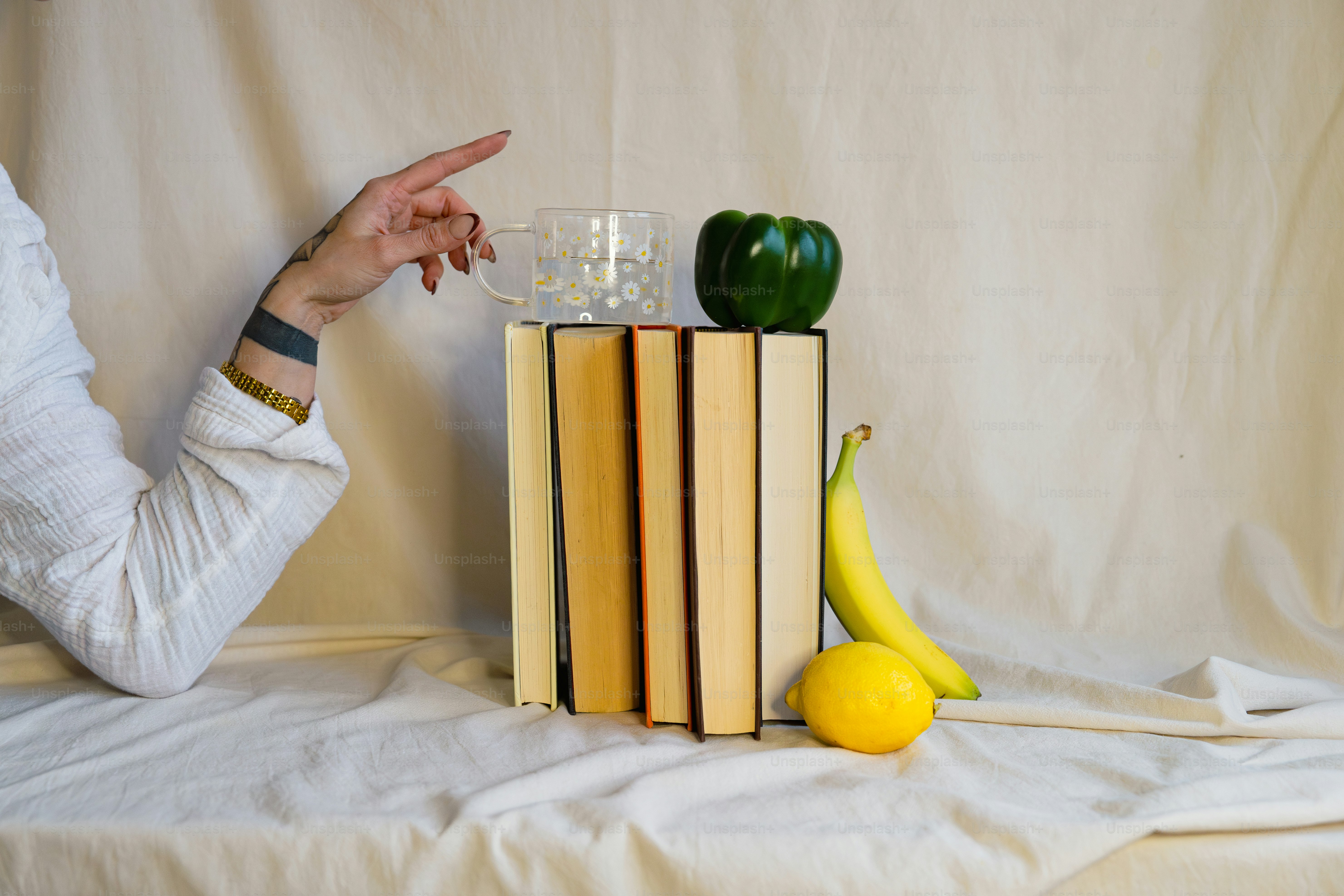 A woman pointing at a stack of books