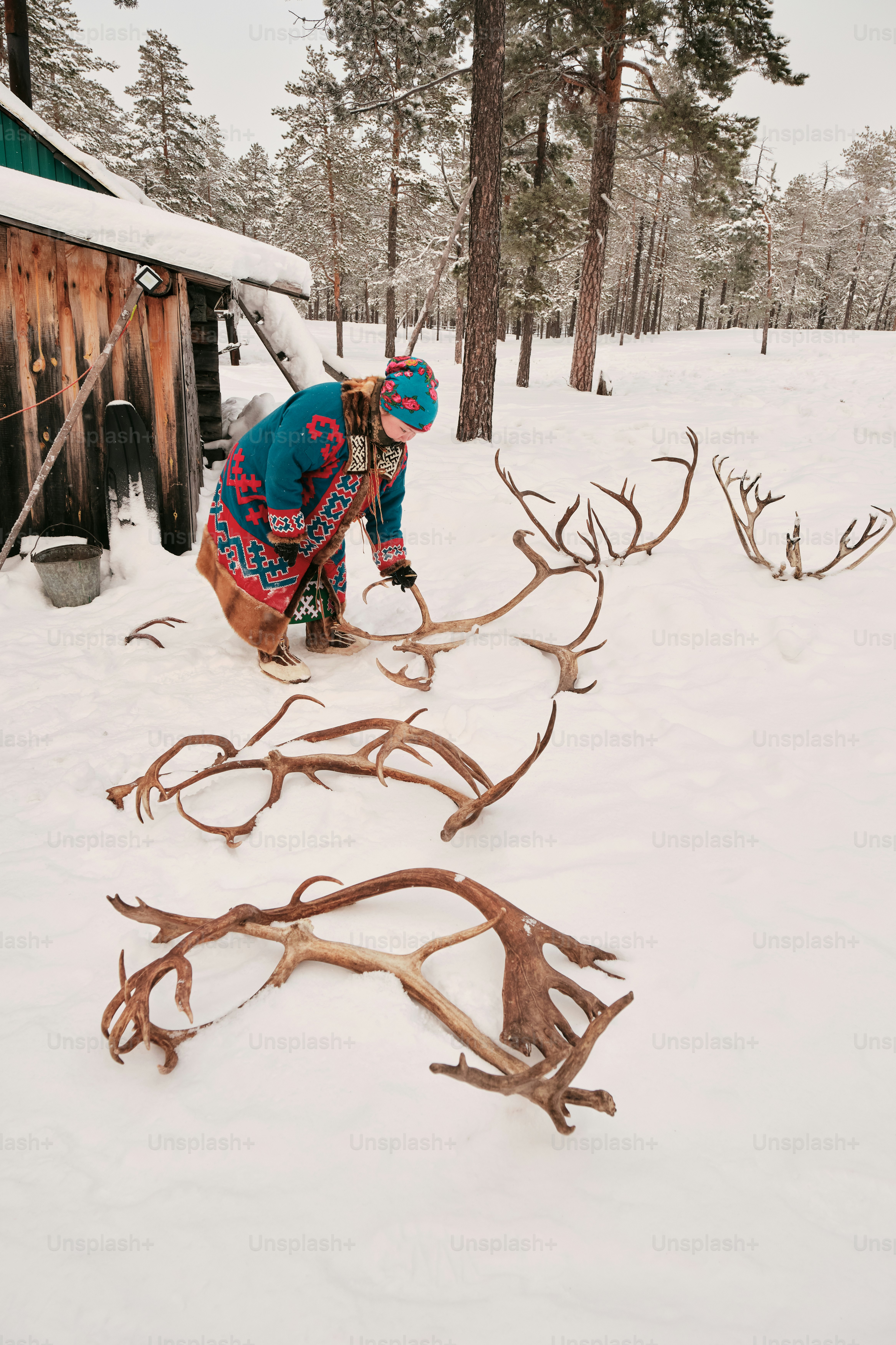 A person bending over to pick up a tree branch
