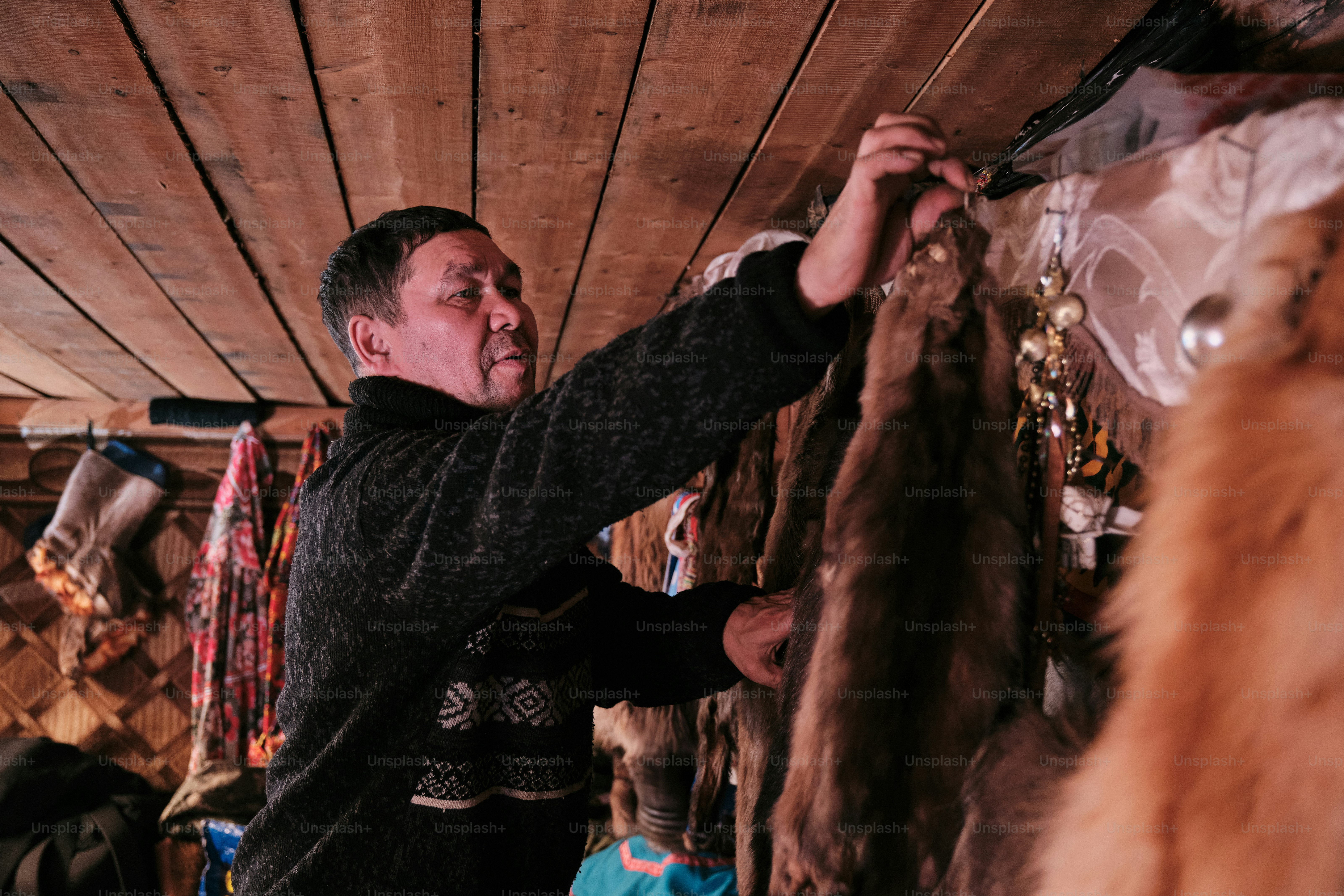 A man standing in front of a bunch of fur